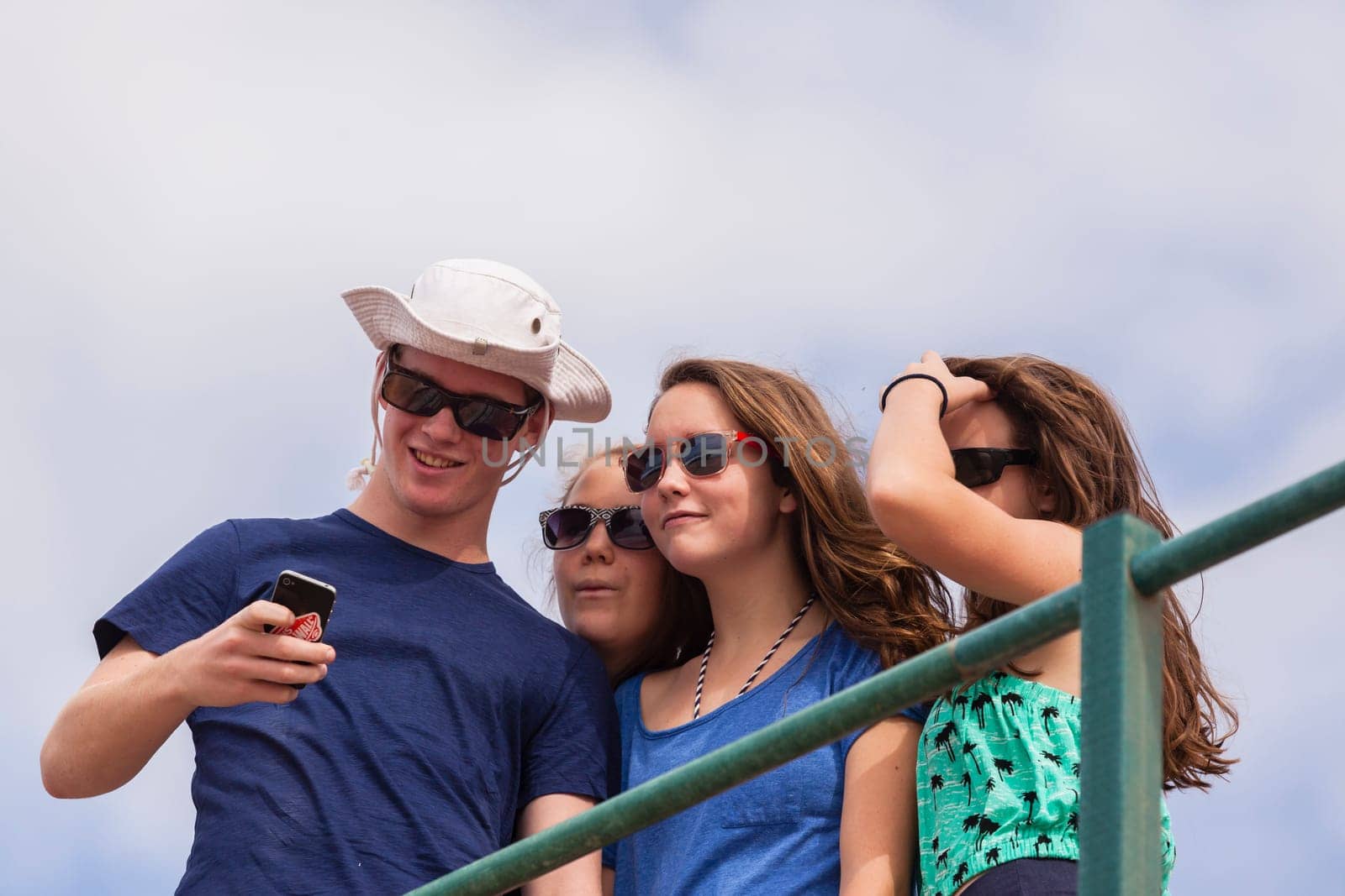 Teenagers at beach holidays talk laughter swimming sea ocean waves