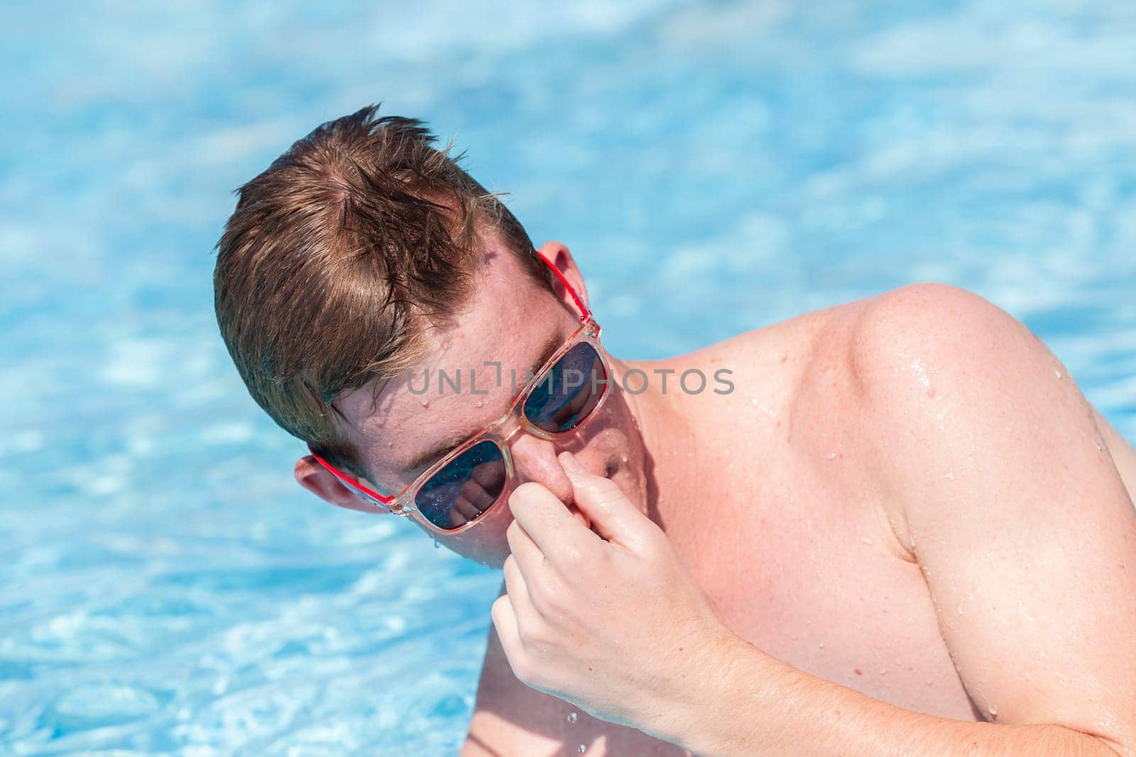 Boy teenager swimming pool summer fun.