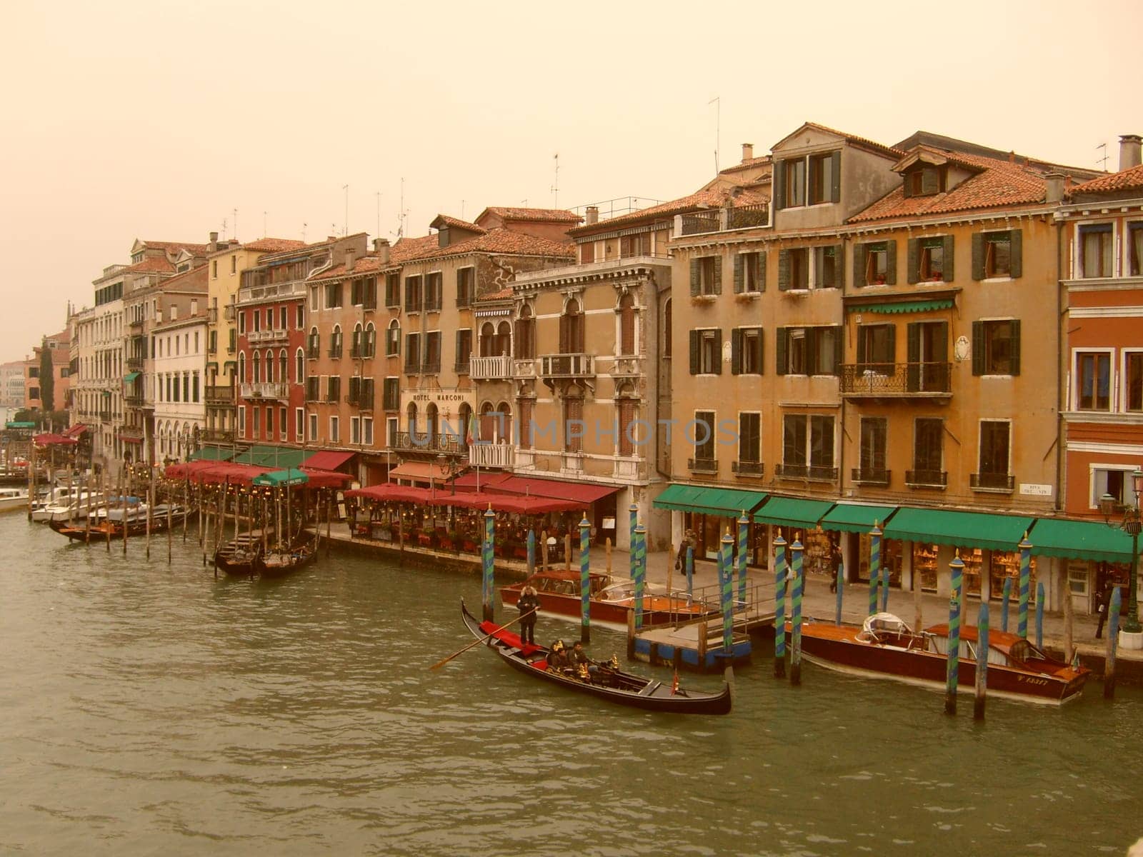 Venice, Italy, 02.22.2007. Venetian streets with graceful building facades. Grand Canal. Along the canal are Gothic and Renaissance palaces. Sights of Italy. Tourism business