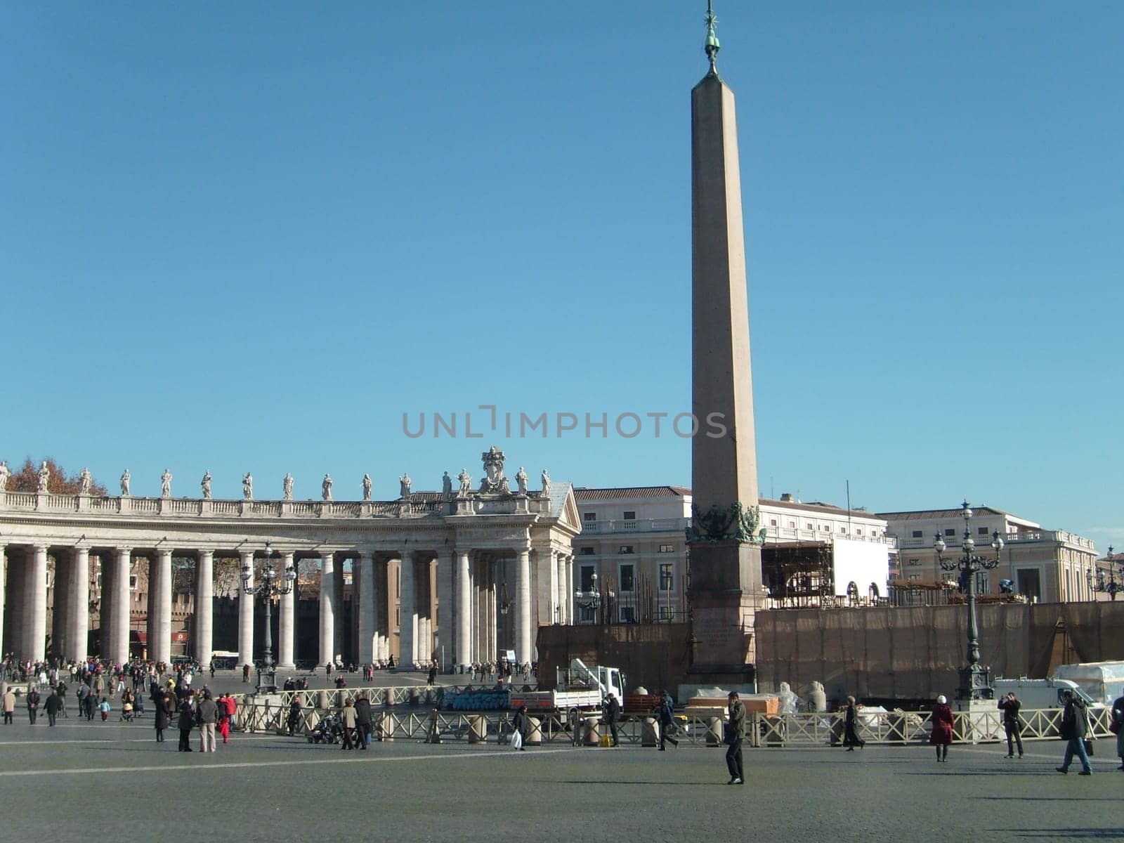 Vatican, Rome, Italy, December 10, 2007, Tuscan order semicircular columns frame St. Peter's Square. Egyptian obelisk from Heliopolis, brought to Rome by Emperor Caligula.