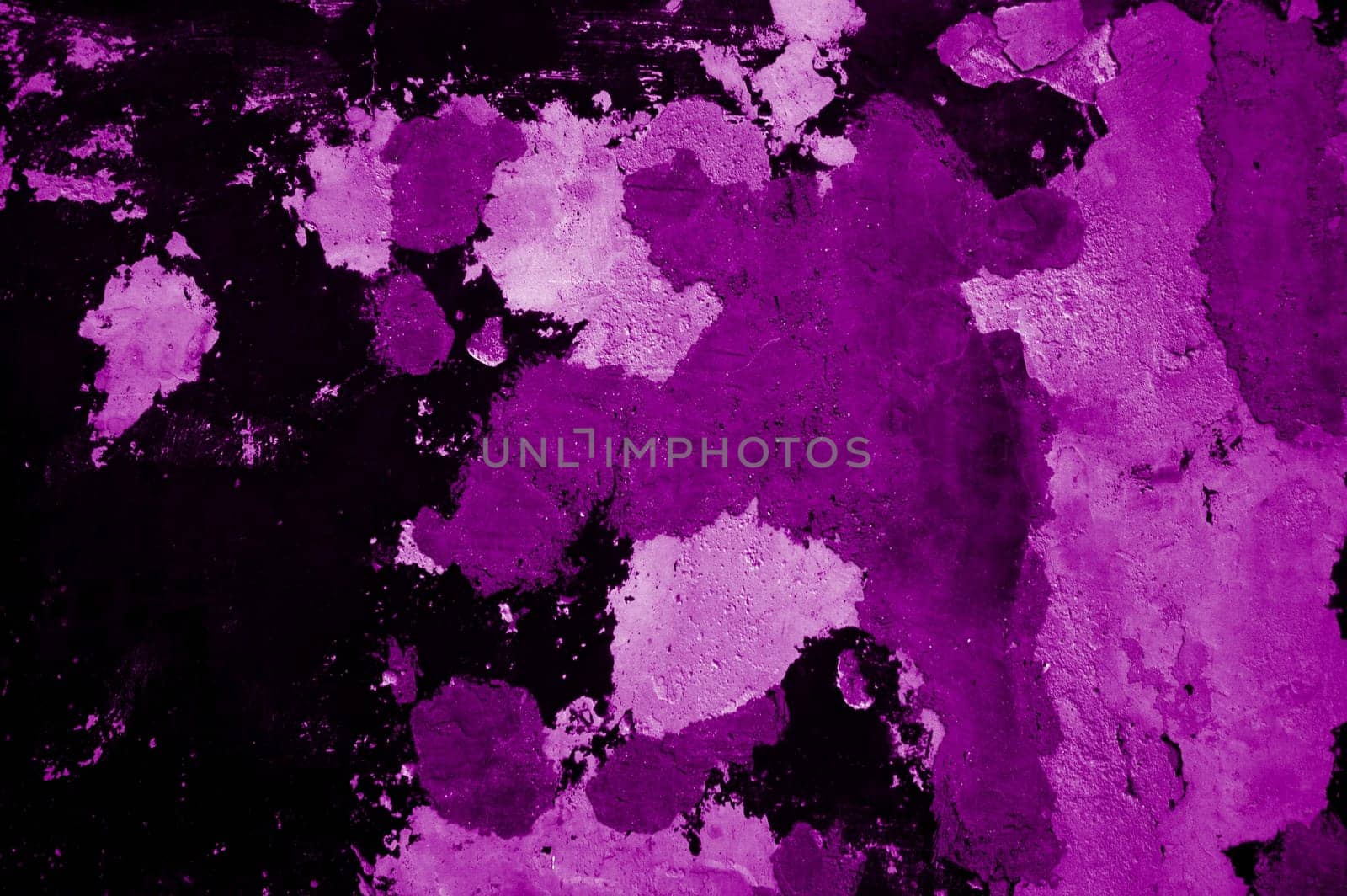 Very old distressed wall with weathered pink purple black color
