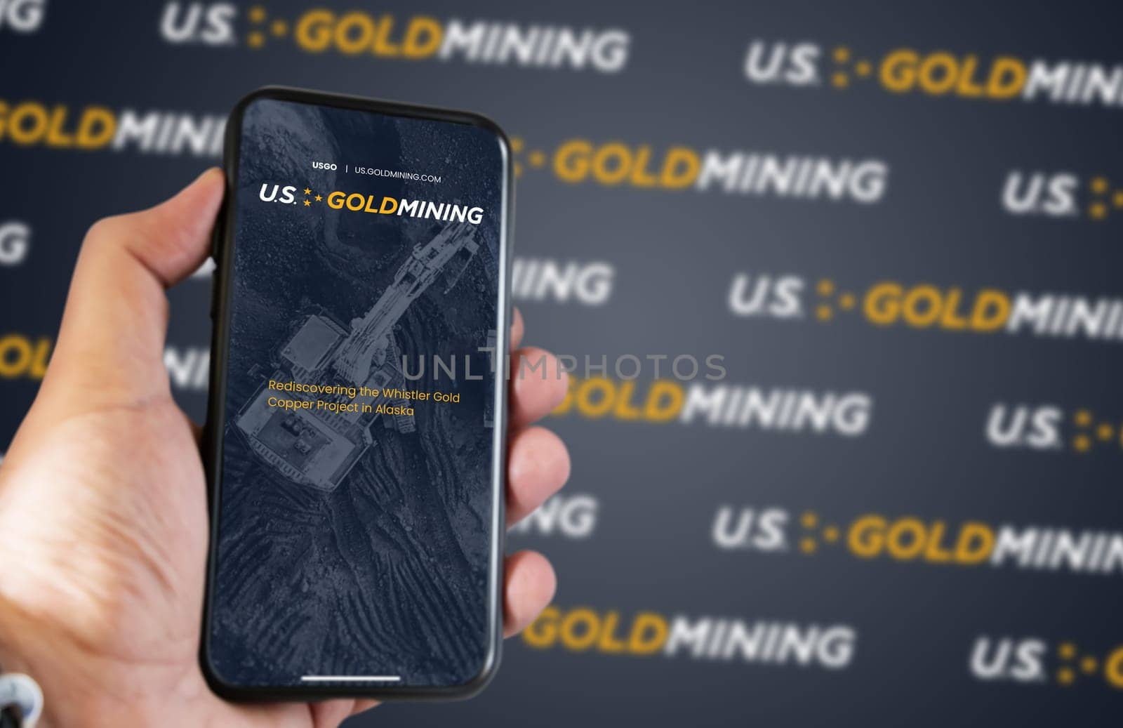New York, USA, March 2023: Hand holding a phone with US GoldMining website on the screen. Financial investment and business. Stock market and money. Illustrative editorial