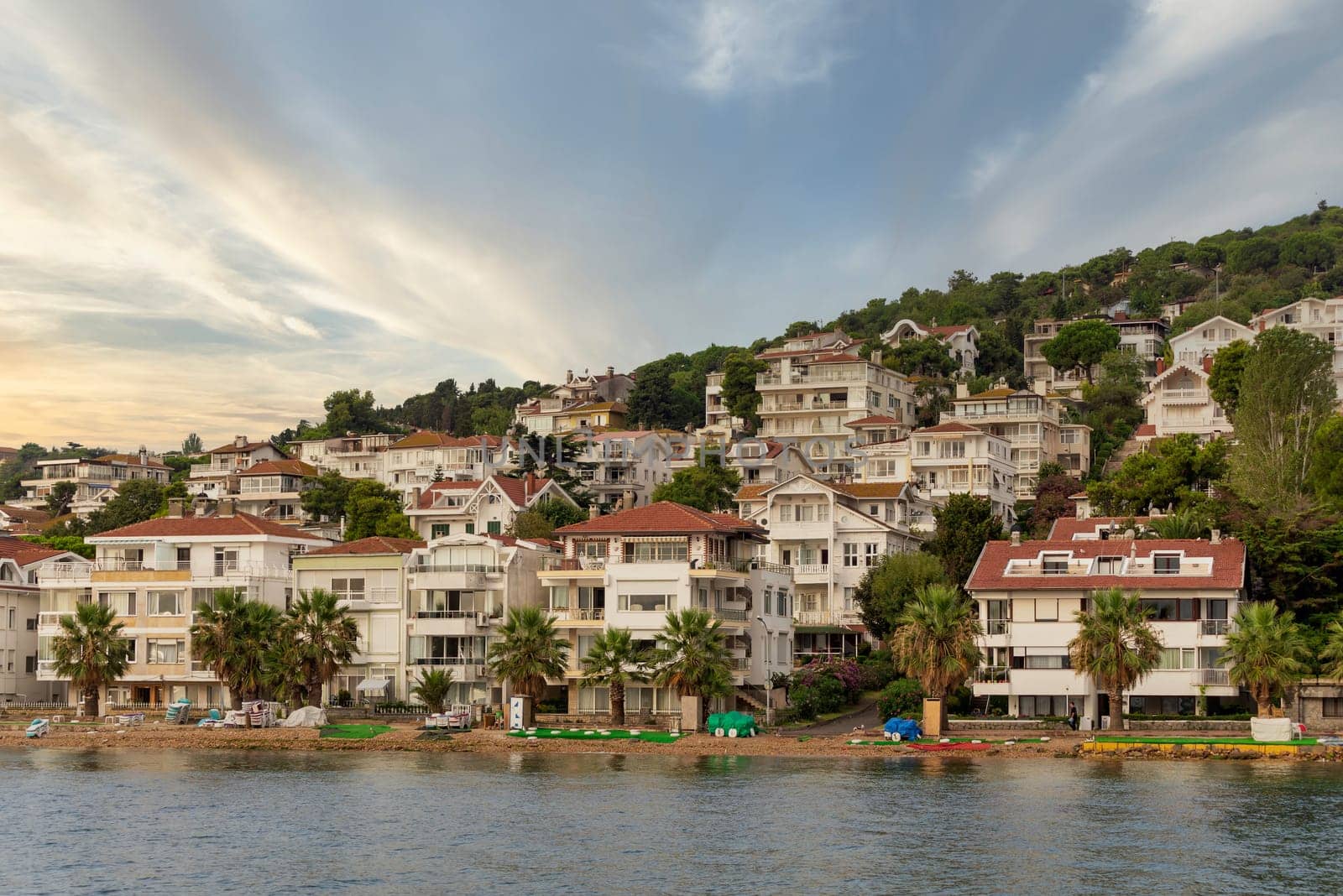 View of the mountains of Kinaliada island from Marmara Sea, with traditional summer houses and boats, Istanbul, Turkey