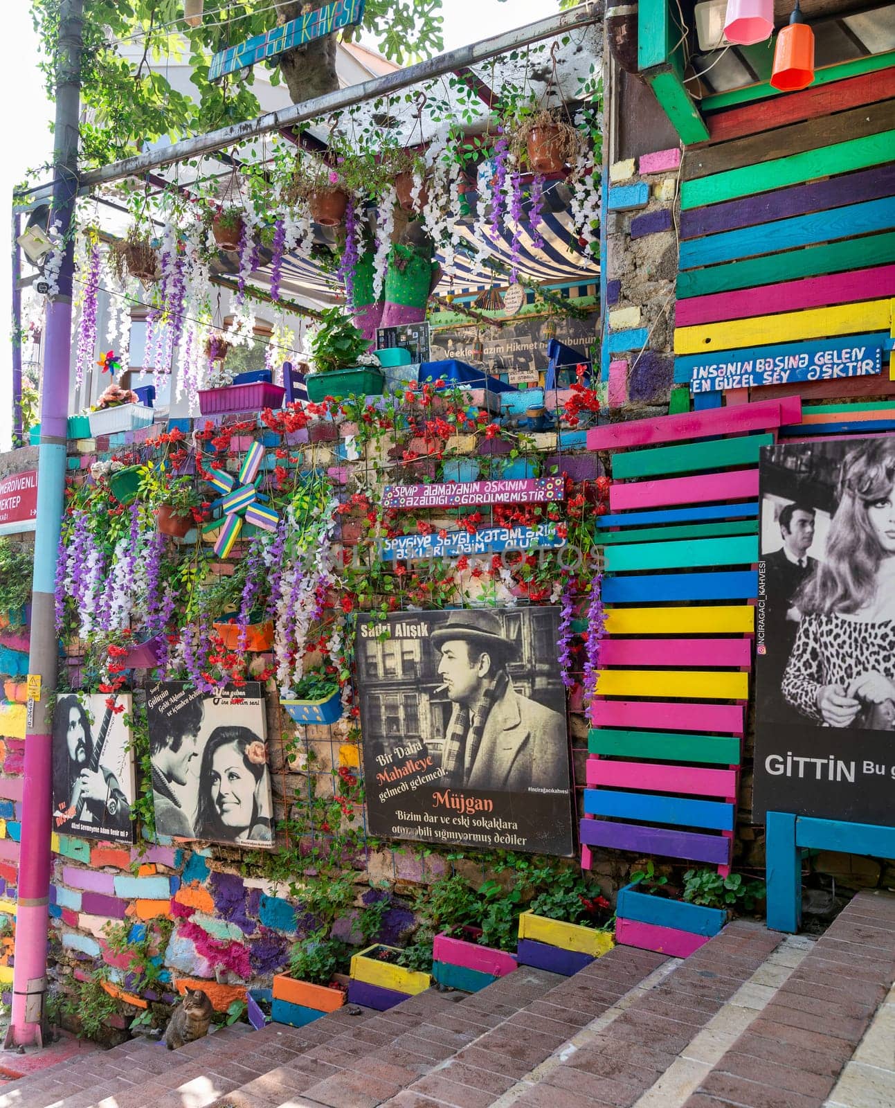 Istanbul, Turkey - August 28, 2022: Exterior daytime shot of traditional cafe decorated with multicolored panels, movie poster, and stairs, in Balat District
