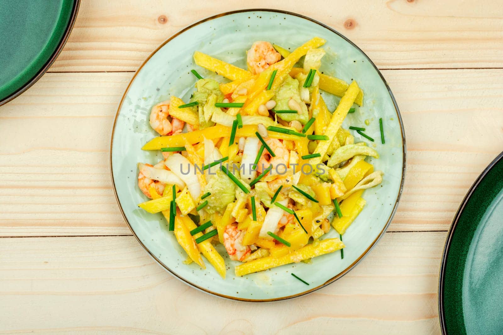 Delicious fresh salad with grilled prawns, mango, avocado and pine nuts. Copy space.