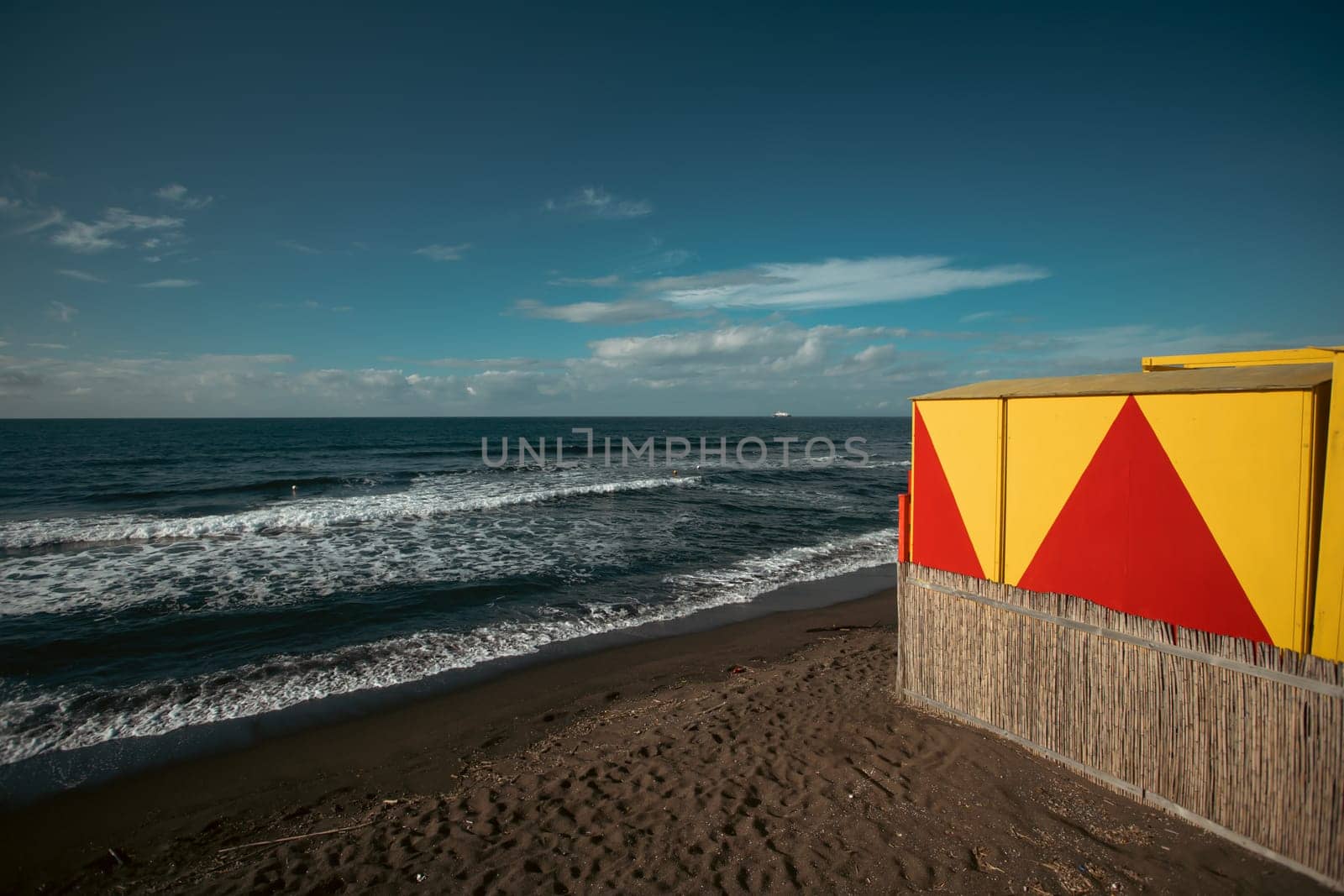 Cozy terrace on the beach, idyllic view of the seashore. Tropical summer vacation concept.