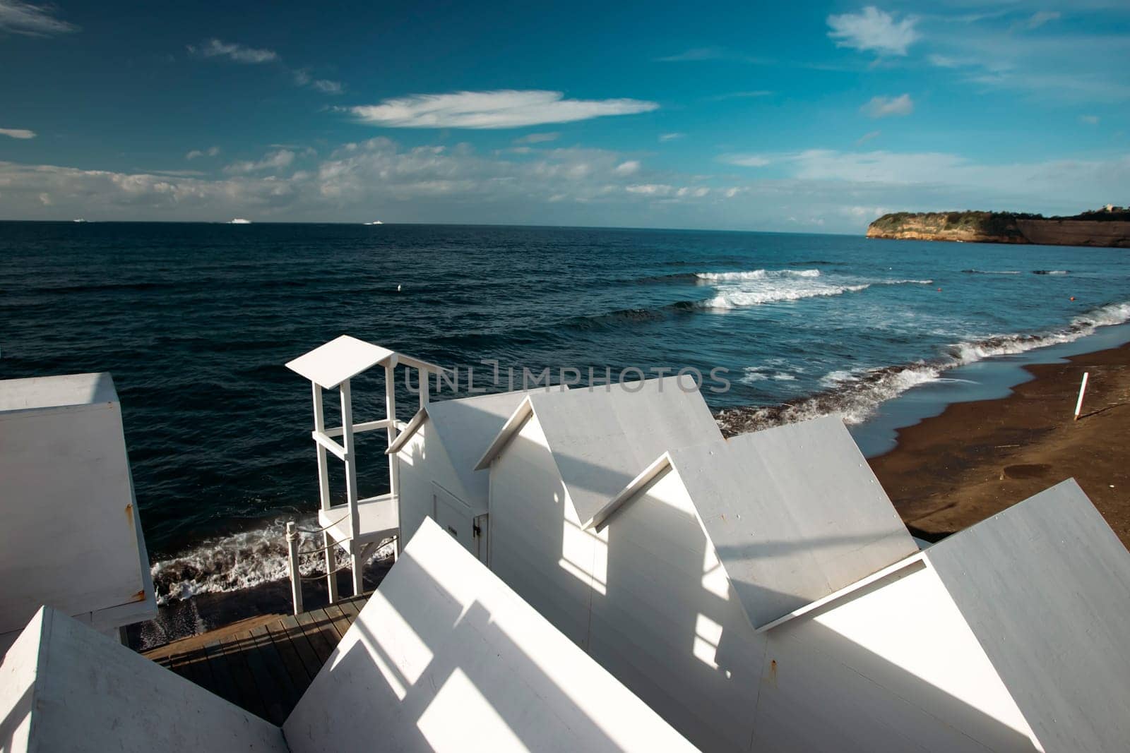 Traditional white wooden beach huts on the beach of Ciraccio, Procida island, Italy