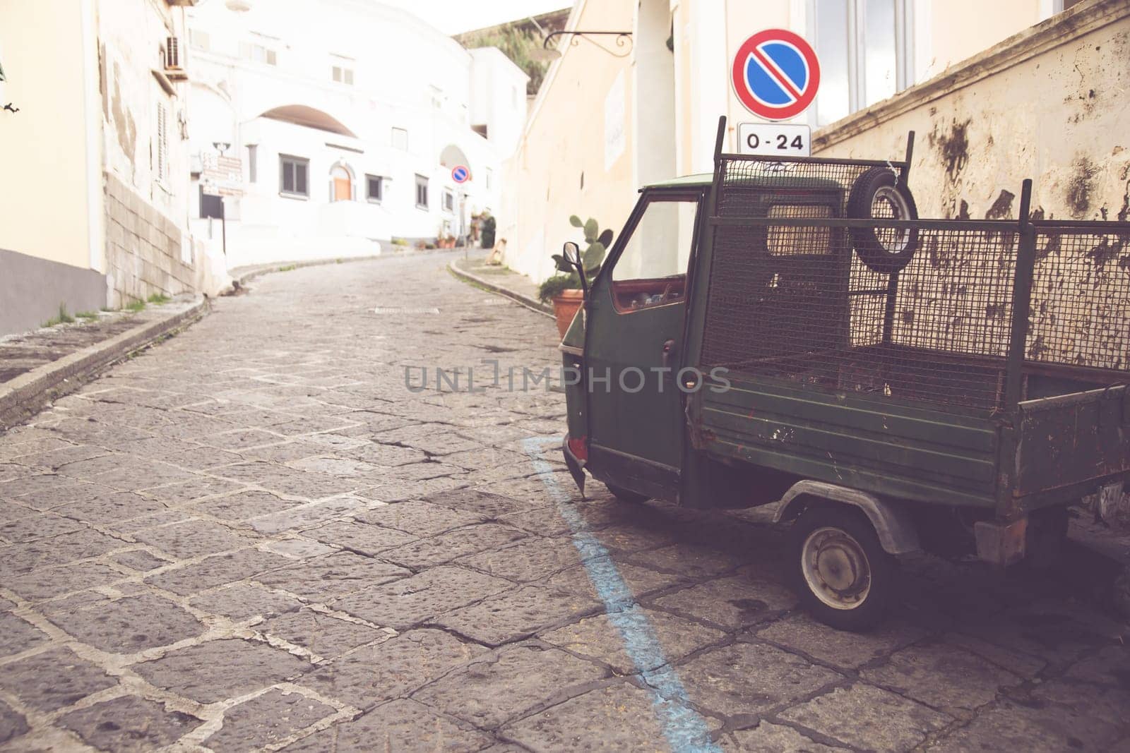 Procida island with colorful houses in small town street