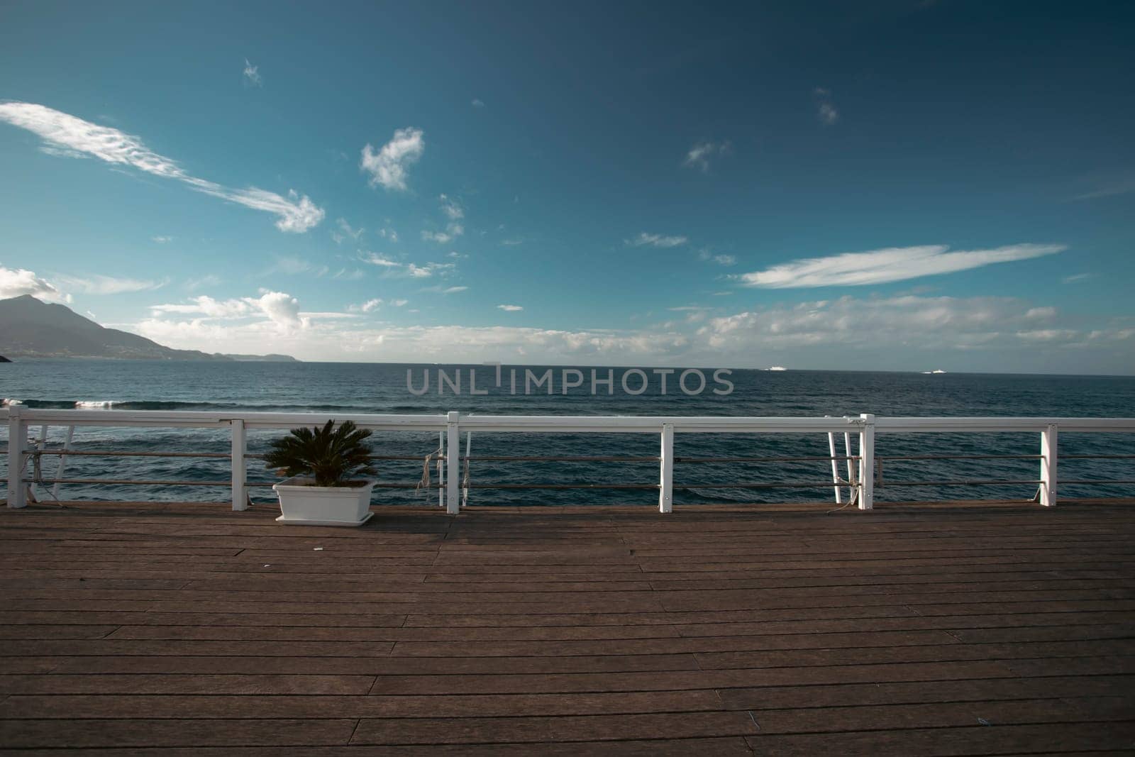 Cozy terrace on the beach, idyllic view of the seashore. Tropical summer vacation concept.