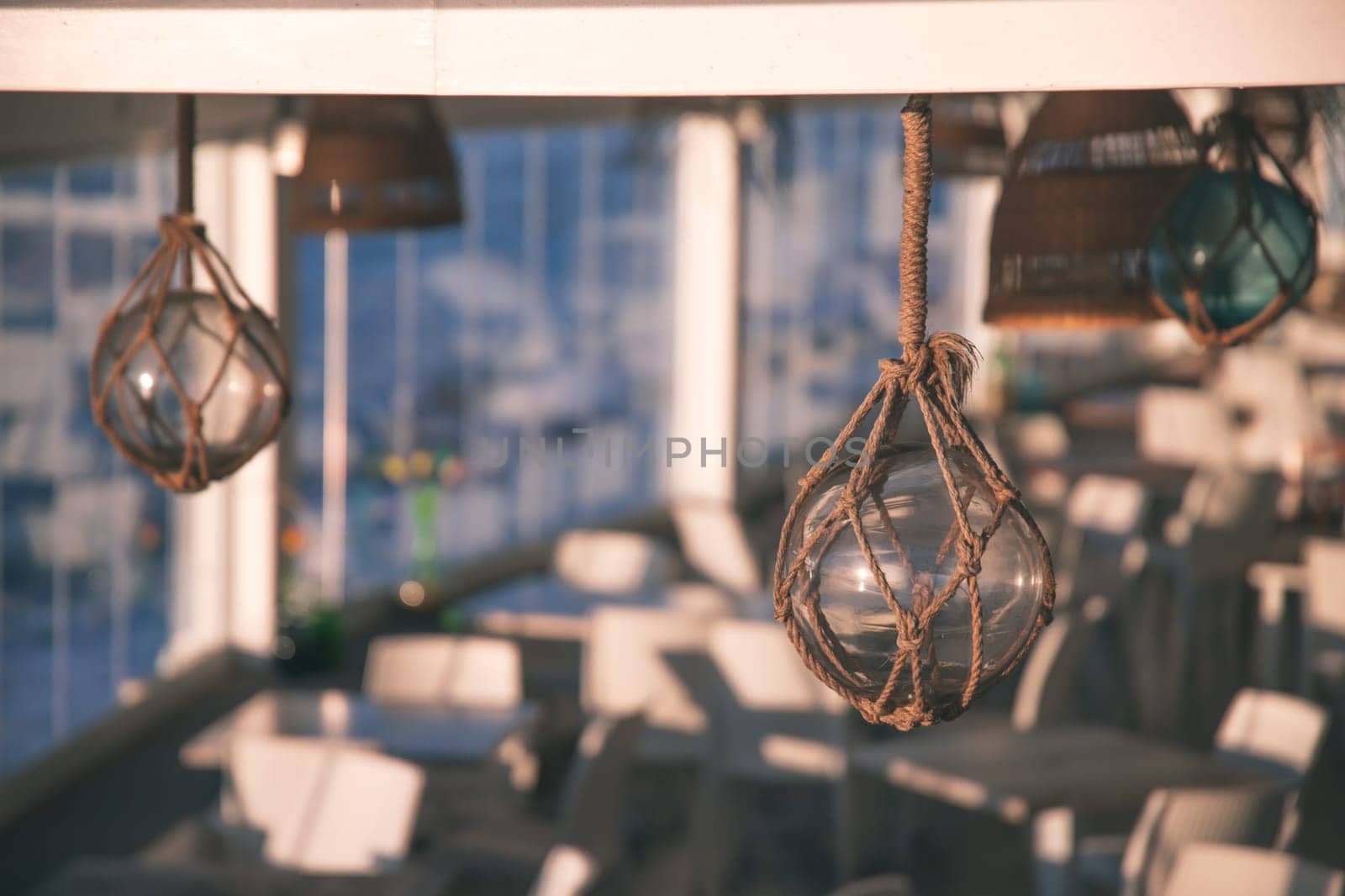 Cozy terrace on the beach, idyllic view of the seashore. Tropical summer vacation concept.