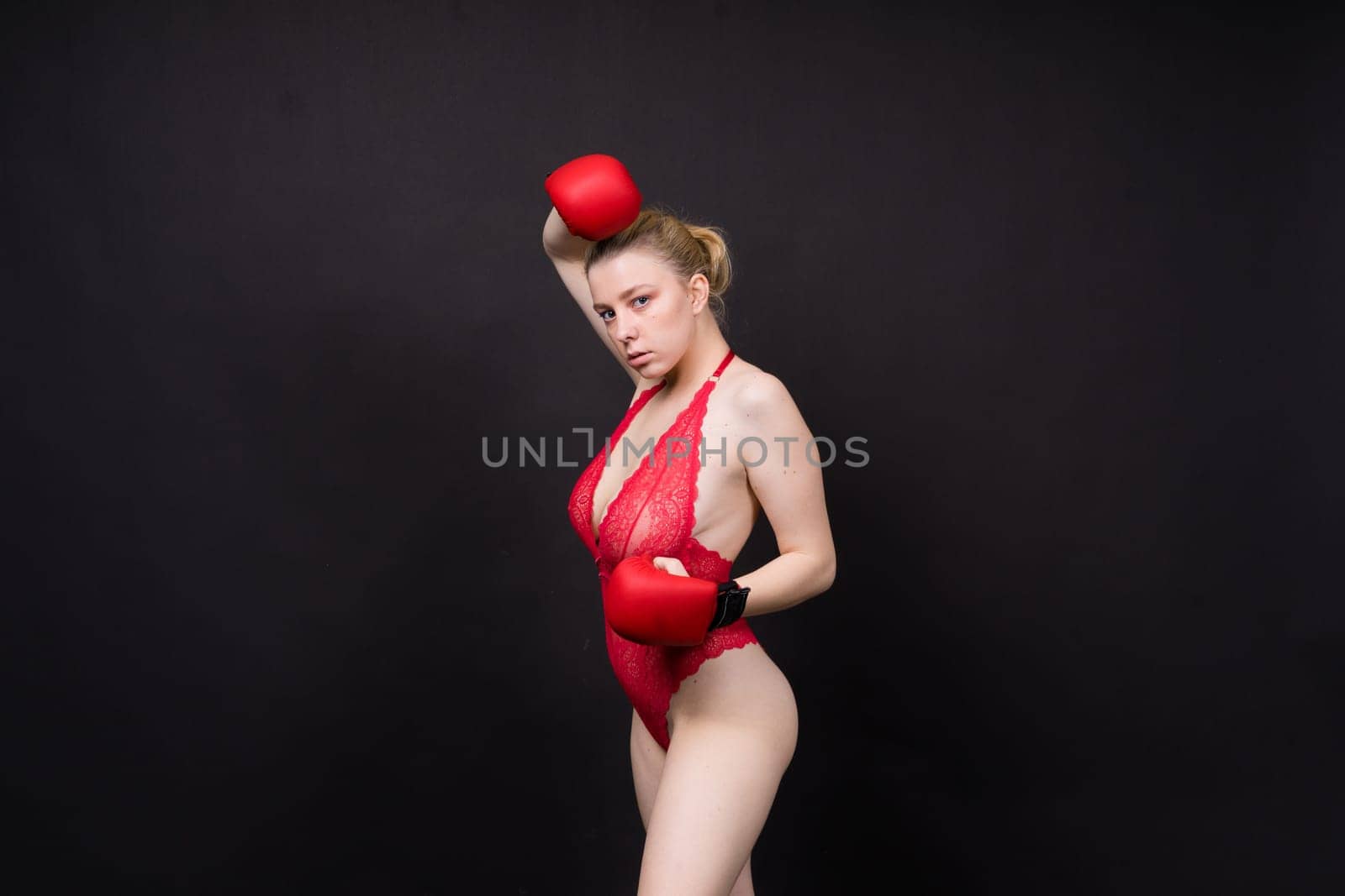 A beautiful, attractive, seductive girl with blonde hair in a studio.