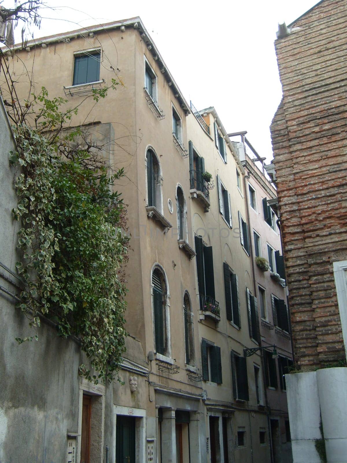 Venice, Italy, 02.22.2007. Venetian streets with graceful building facades. Grand Canal. Along the canal are Gothic and Renaissance palaces. Sights of Italy. Tourism business