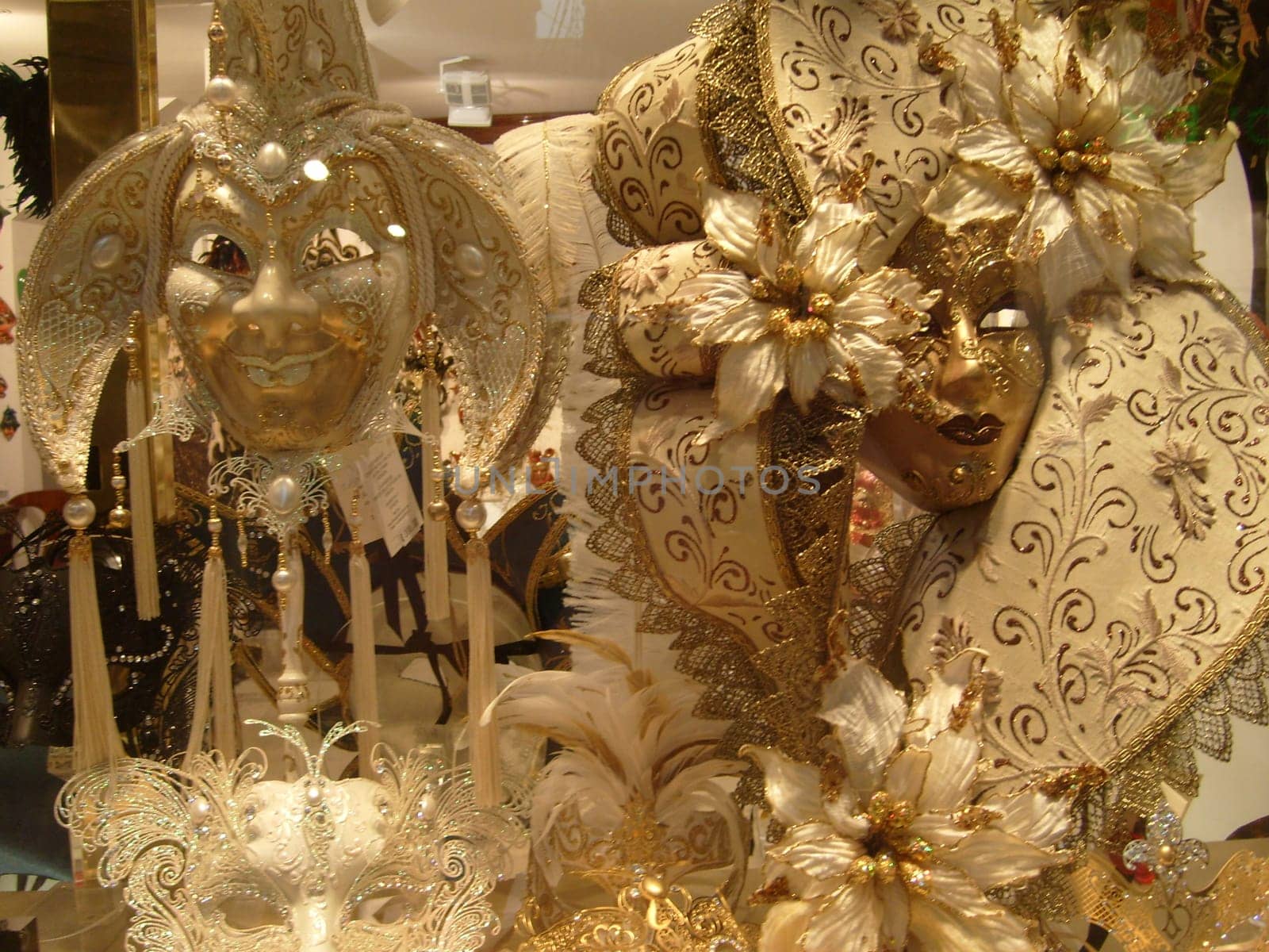 Venice, Italy, September 24, 2020. Venetian masks in a shop window, side view. Beautiful graceful bright carnival masks.