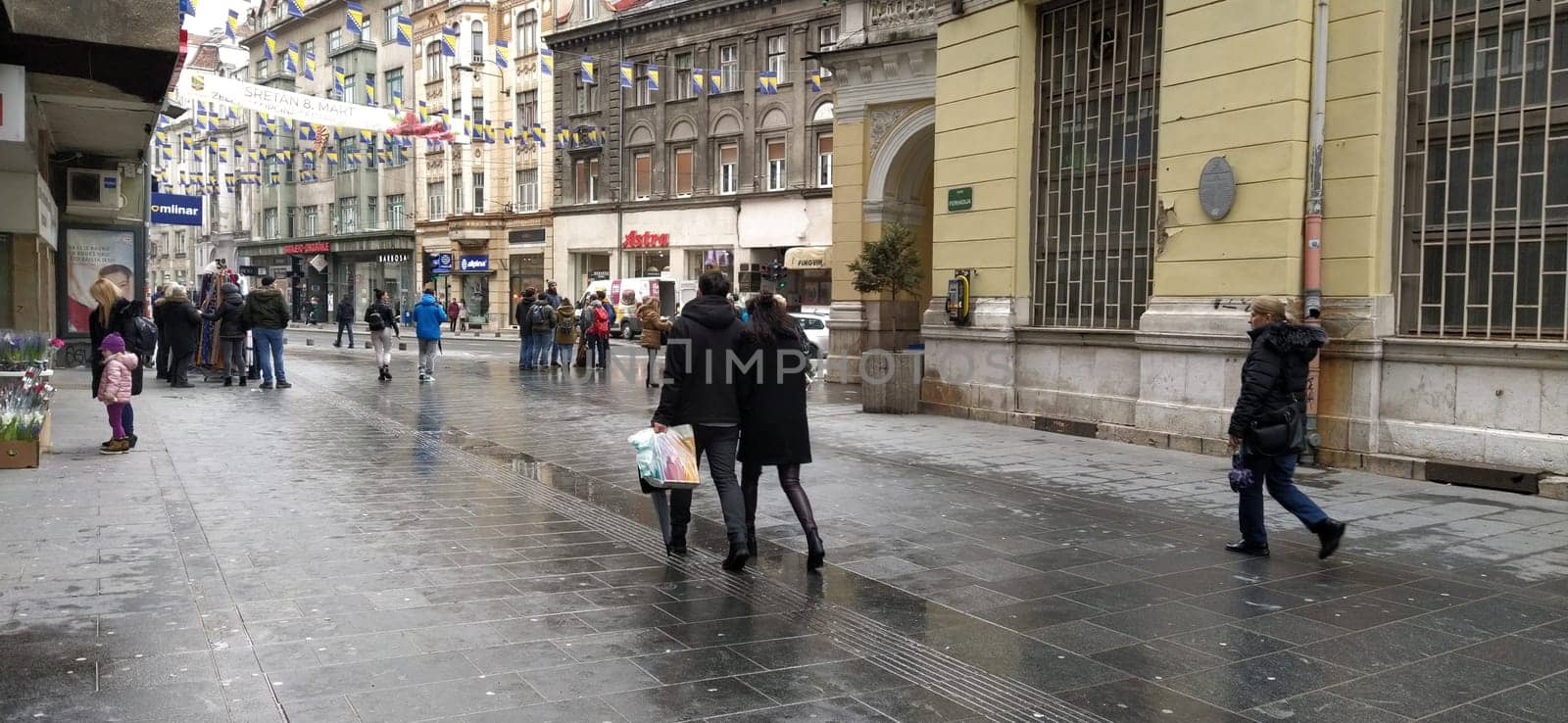 Sarajevo, Bosnia and Herzegovina, March 8, 2020. People on the streets of Sarajevo. Tourists and locals walk around the city center, visit shops, cafes. Historic Center of Sarajevo with Attractions.