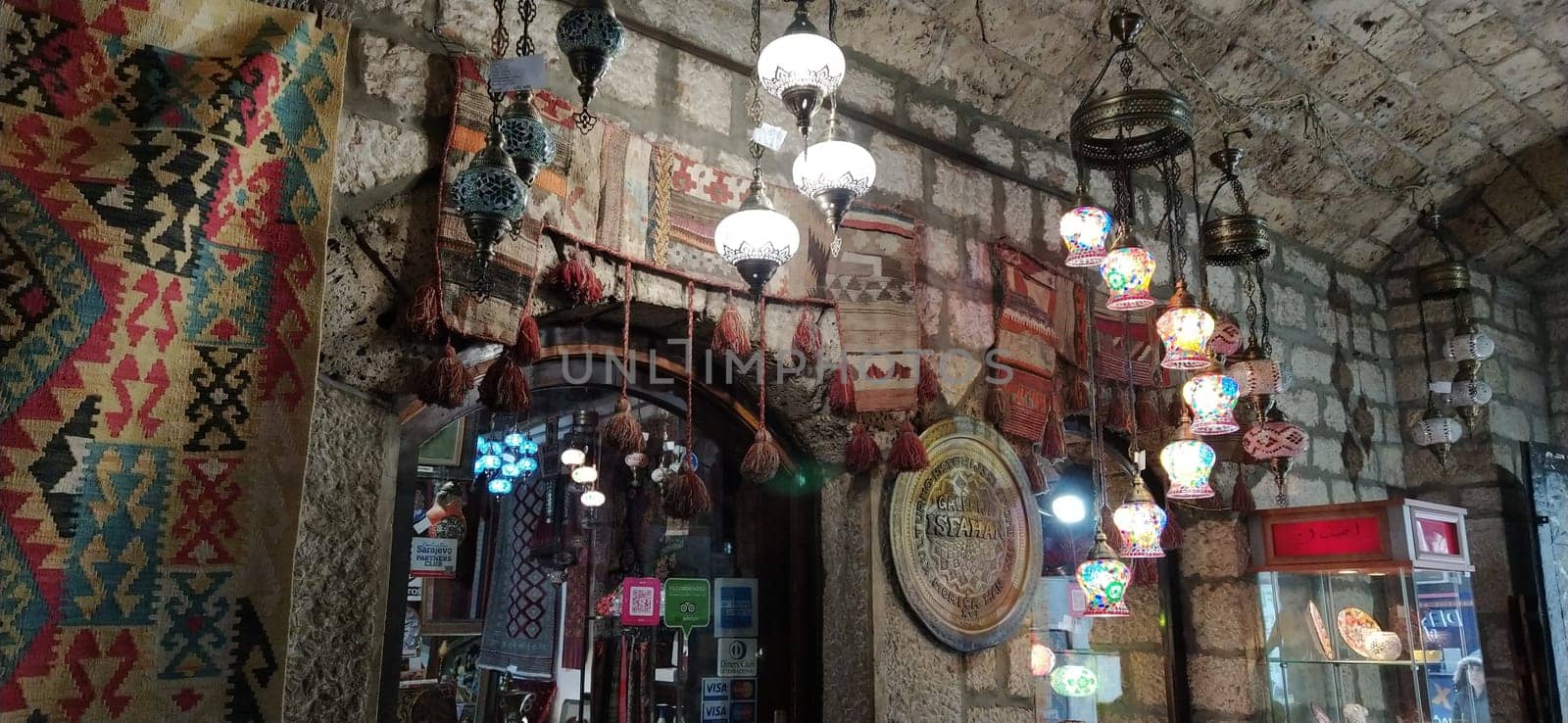 Traditional vintage Turkish lamps over light background in the night. Colored glass lamps and shades on the market in Sarajevo, Bosnia and Herzegovina. Sale of souvenirs in the market
