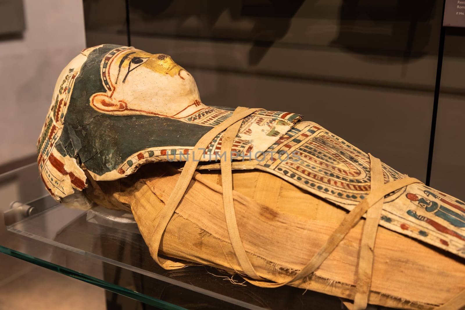 Turin, Italy - March 2023: Egyptian Museum, mummy of a baby with a mask - 2nd Century BC