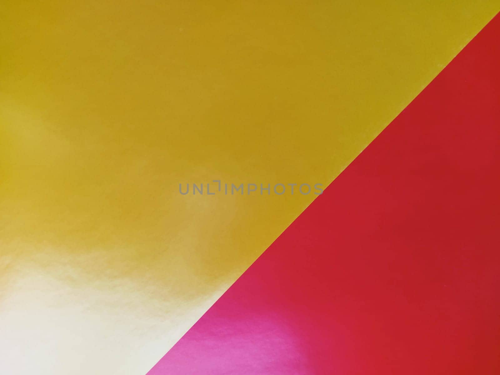 Yellow-pink bright background. Diagonally laid sheets of colored paper with a gradient and light flare.