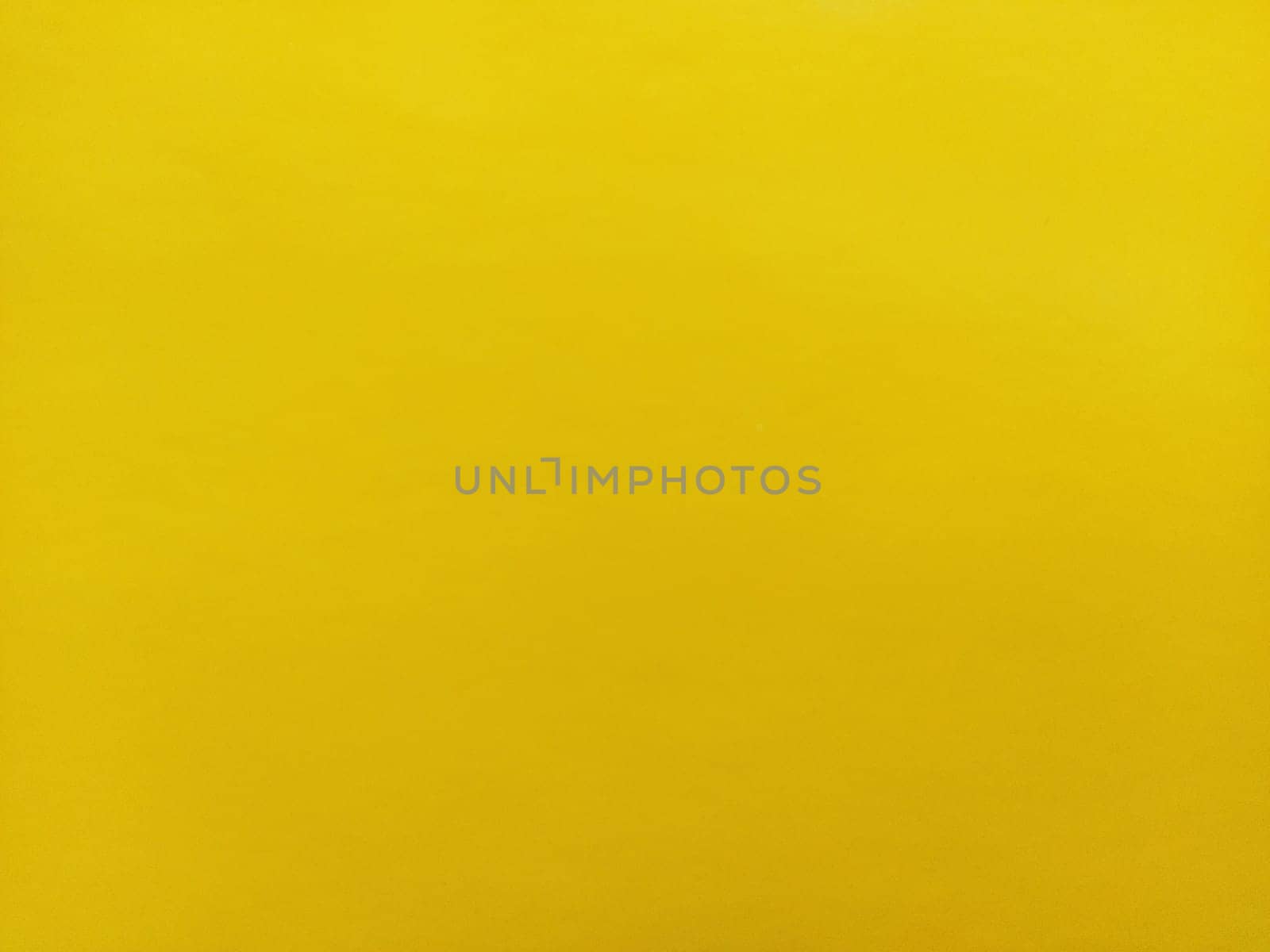 Nice yellow background. A sheet of paper close-up. Pure cheerful color. Vivid shade of yellow.