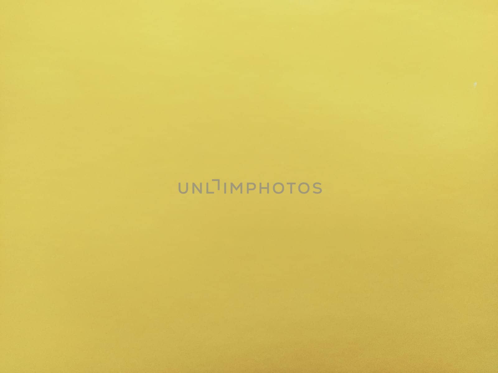 Nice yellow background. A sheet of paper close-up. Pure cheerful color. Vivid shade of yellow.