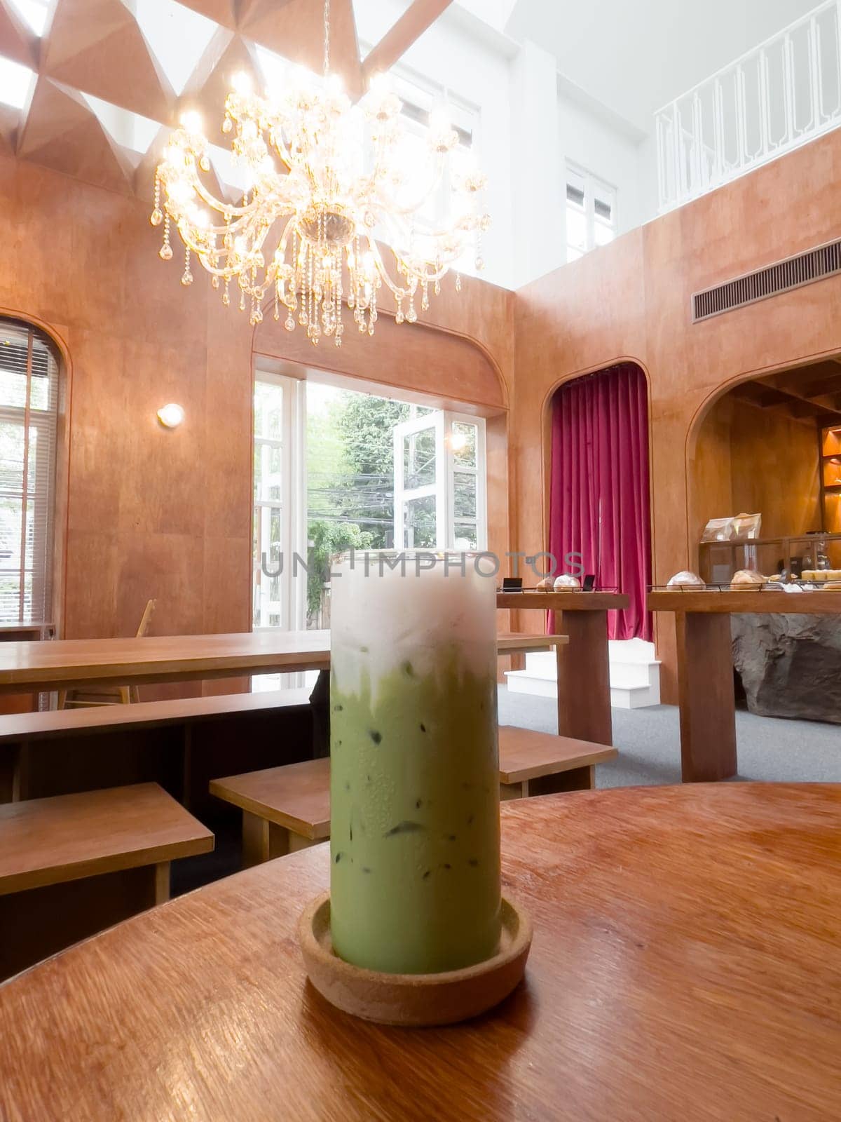 Iced matcha greentea on wooden table in coffee shop, stock photo