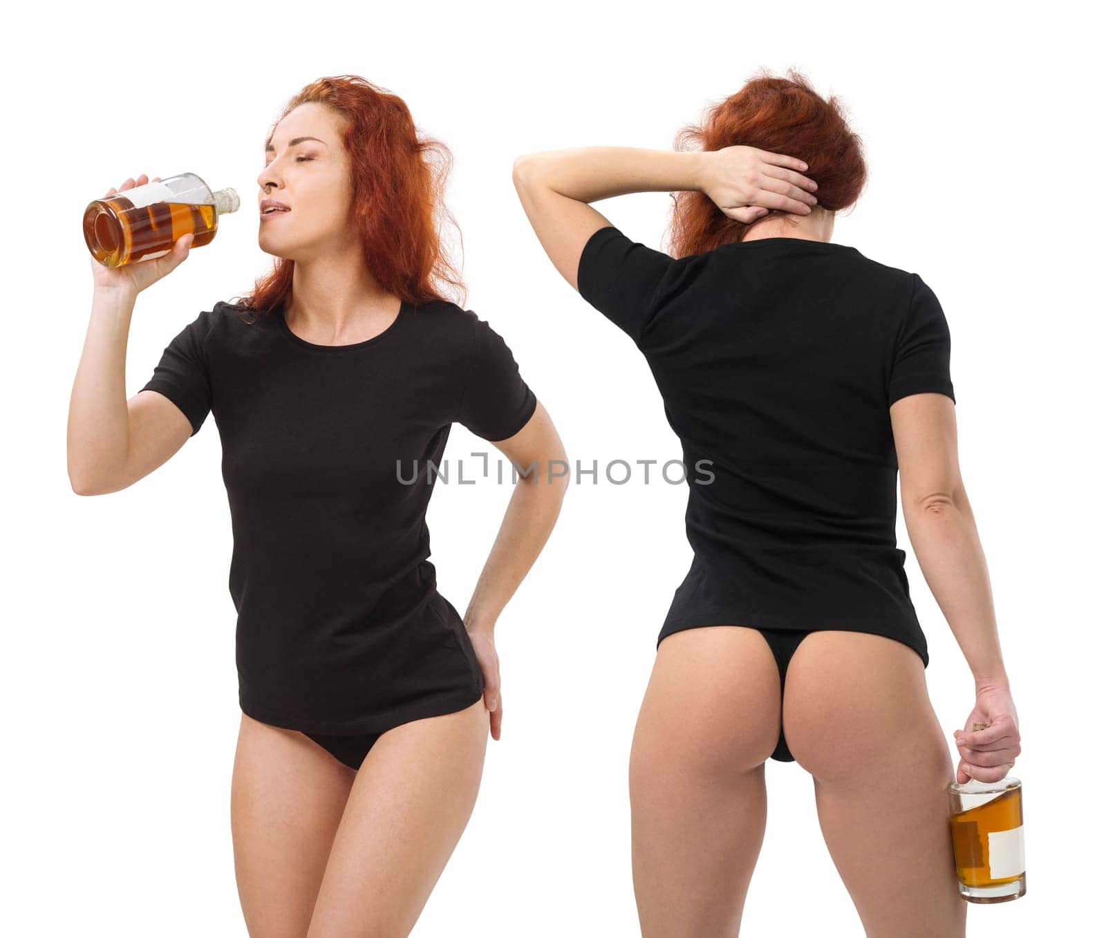 Photo of a young beautiful redhead woman with blank black shirt and black underwear, drinking whisky from a bottle. Isolated over white background and ready for your design or artwork.