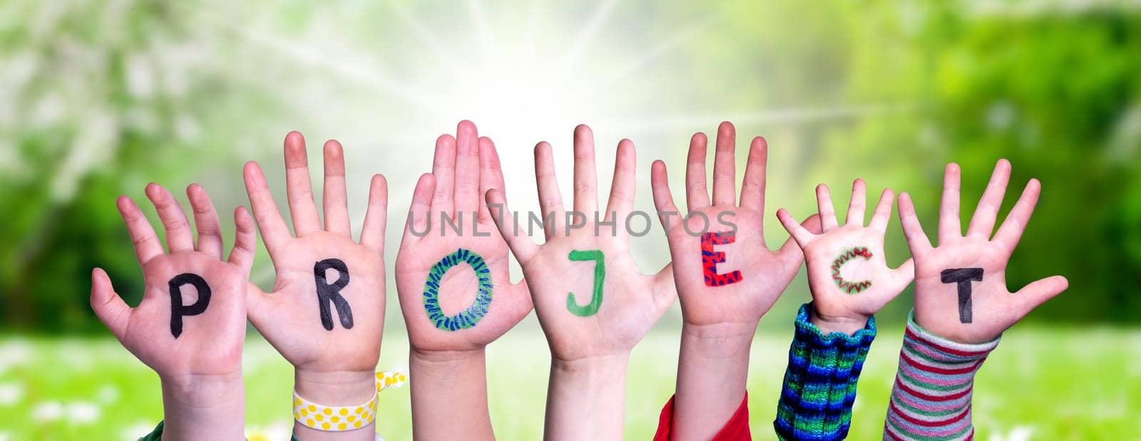 Children Hands Building Colorful English Word Project. Summer, Sunny Green Grass Meadow As Background