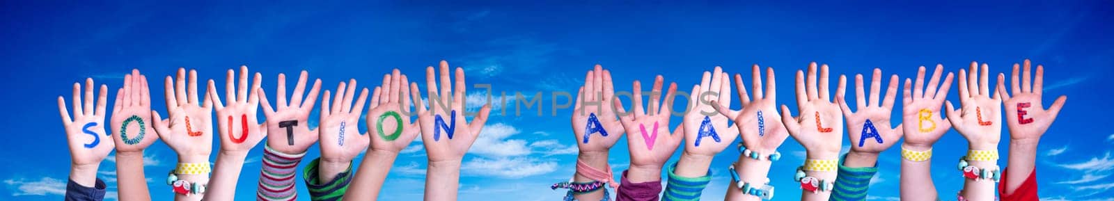 Children Hands Building Colorful English Word Solution Available. Blue Sky As Background