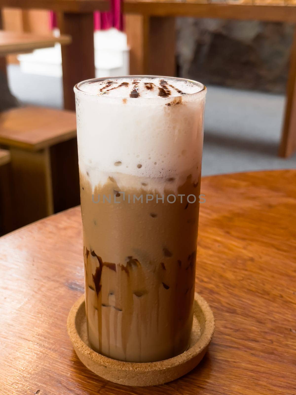 Iced matcha greentea on wooden table in coffee shop, stock photo
