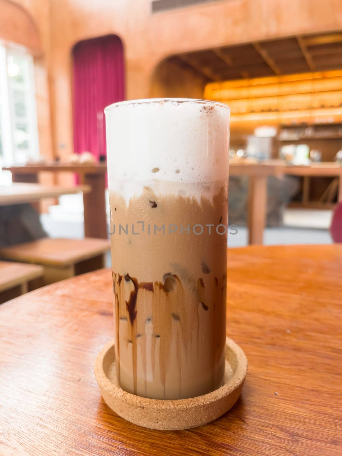 Iced matcha greentea on wooden table in coffee shop, stock photo