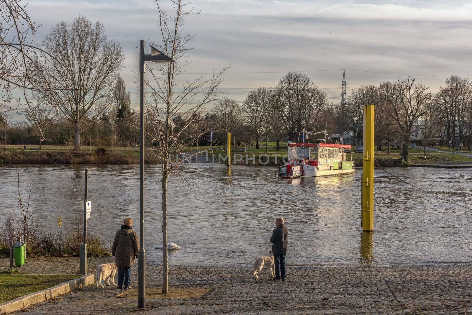 Unidentified people are waiting for the Main ferry in Frankfurt Höchst, Germany