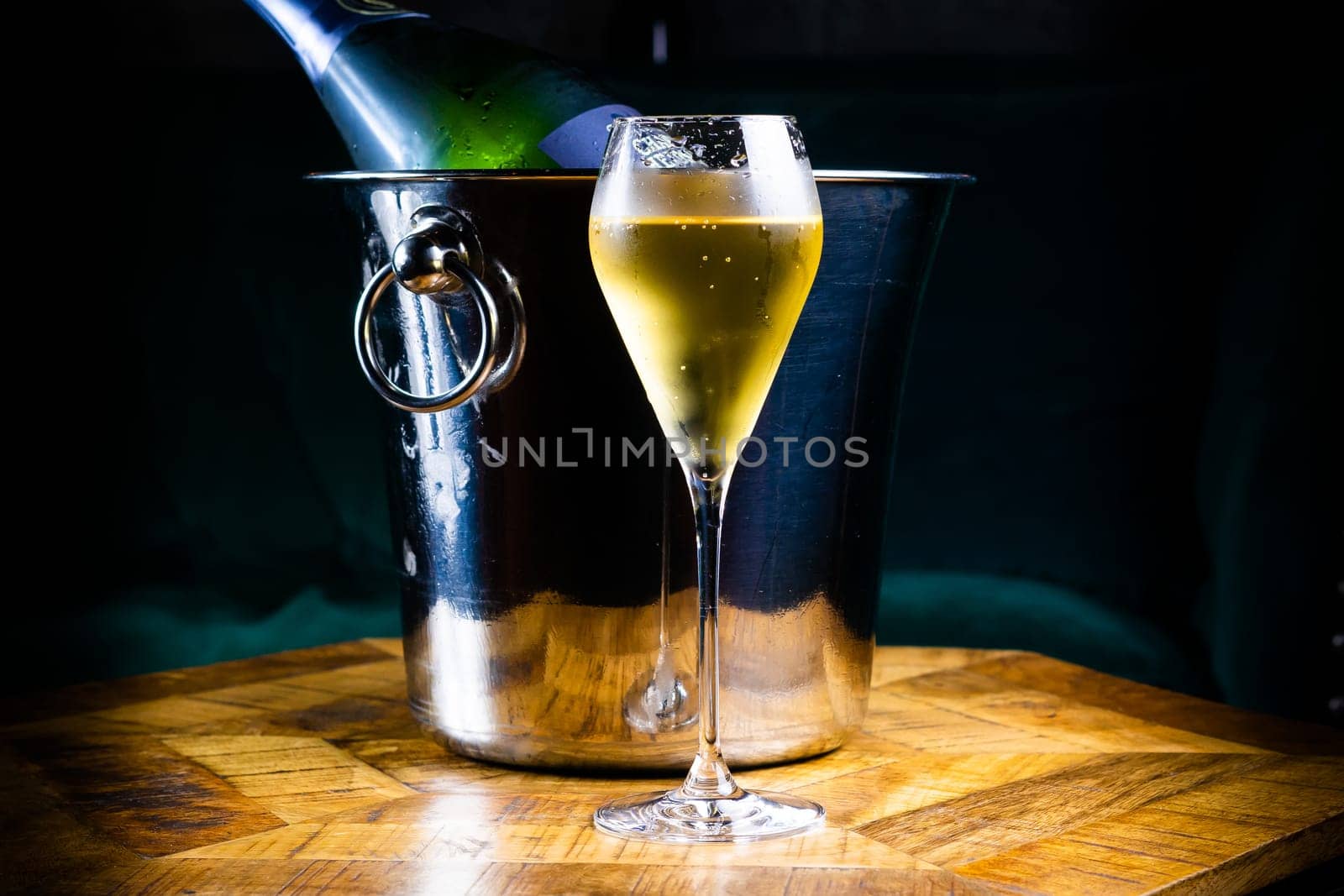 Stemmed cocktail glass with alcoholic drink, closeup isolated on black. Template design