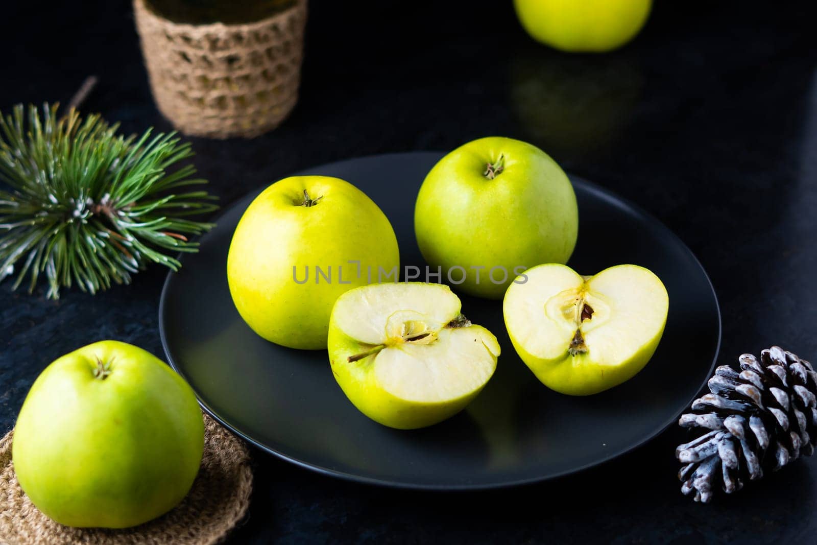 Ripe green apple fruits on a dark stone table. Top view with copy space. Flat lay