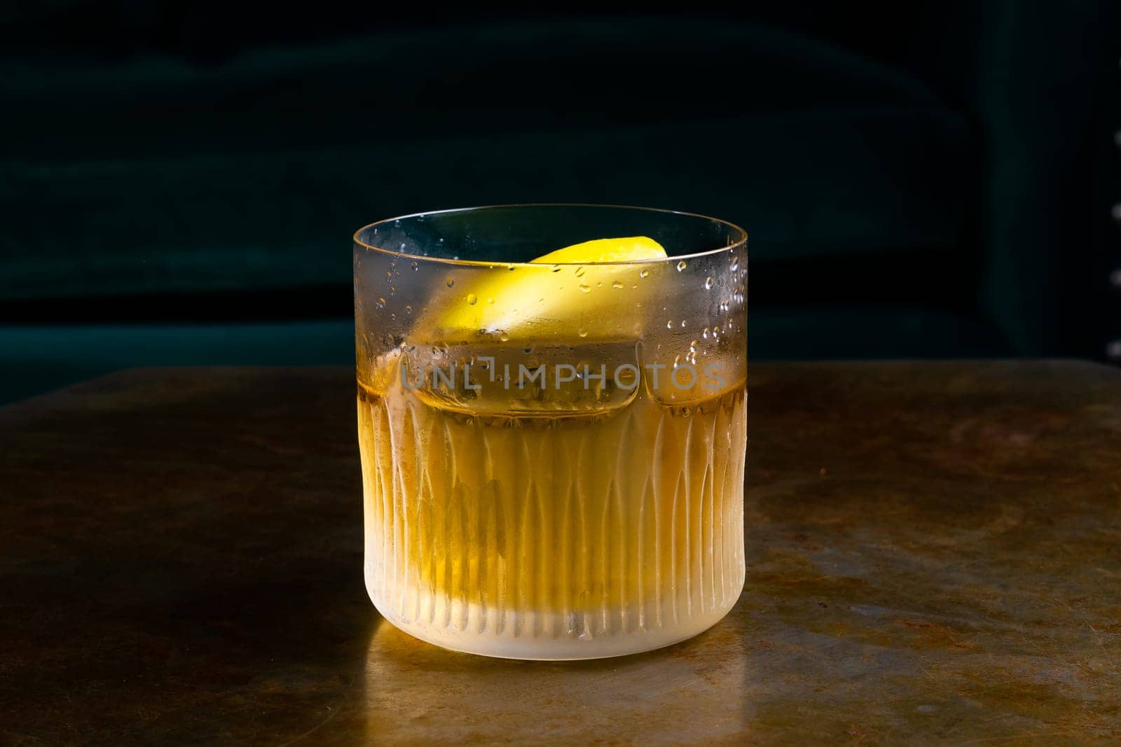 Stemmed cocktail glass with alcoholic drink, closeup isolated on black. Template design