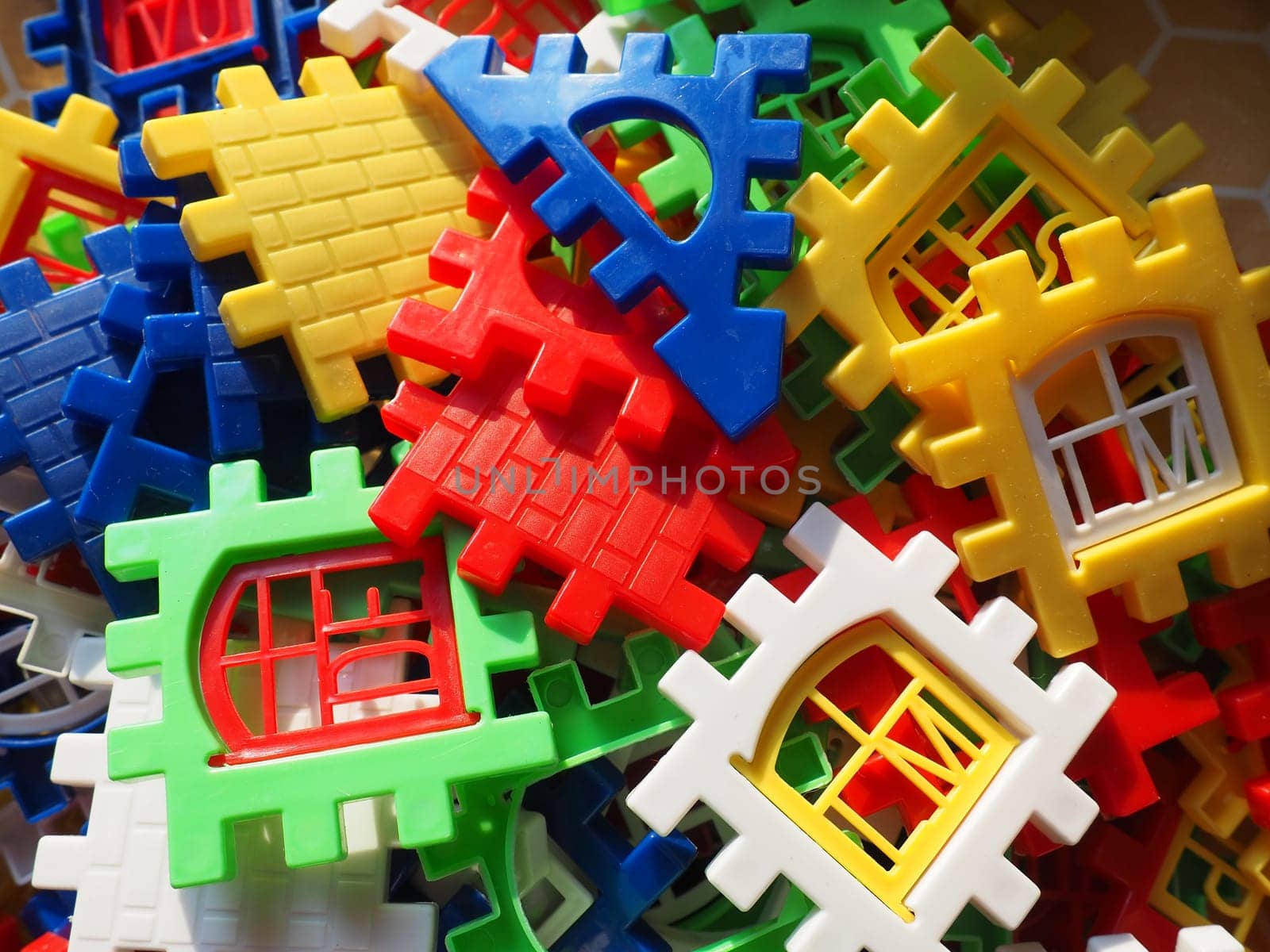 children's designer toy. Plastic bright multi-colored blocks for playing and developing the imagination and fine motor skills of the child's hands. Toy house construction.