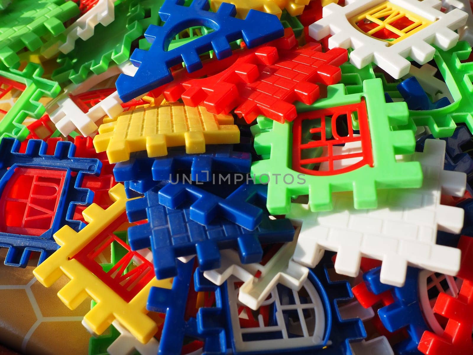 children's designer toy. Plastic bright multi-colored blocks for playing and developing the imagination and fine motor skills of the child's hands. Toy house construction.