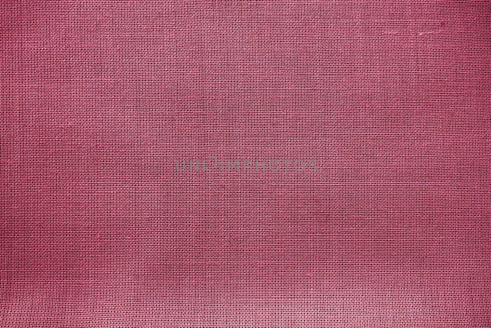 Cloth close-up. Interlacing of threads. A piece of pink fabric. Fabric background. Copy space.