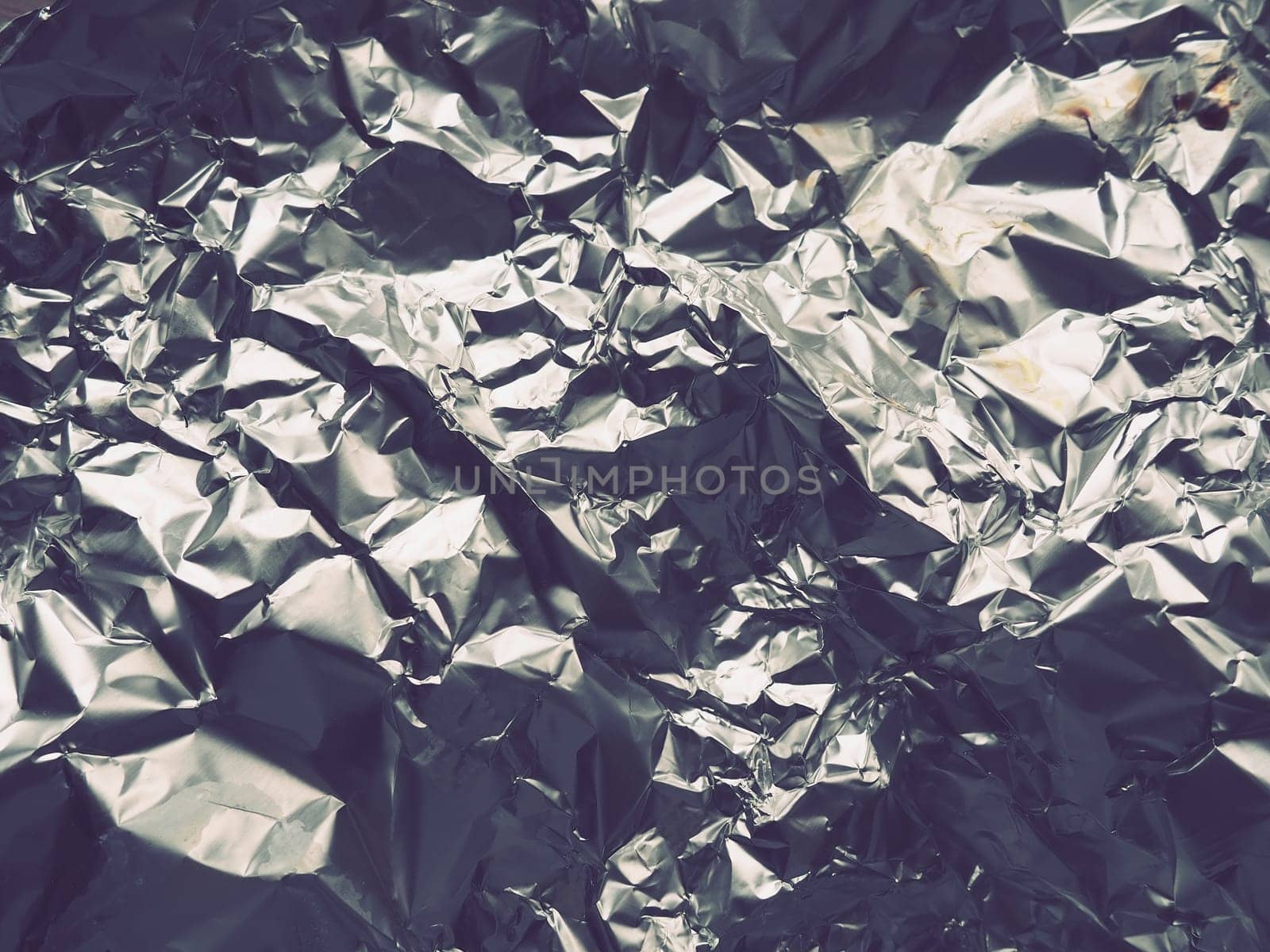 foil close-up. Aluminum silver crumpled foil. Abstract metallic background. Foil for baking food. Background.