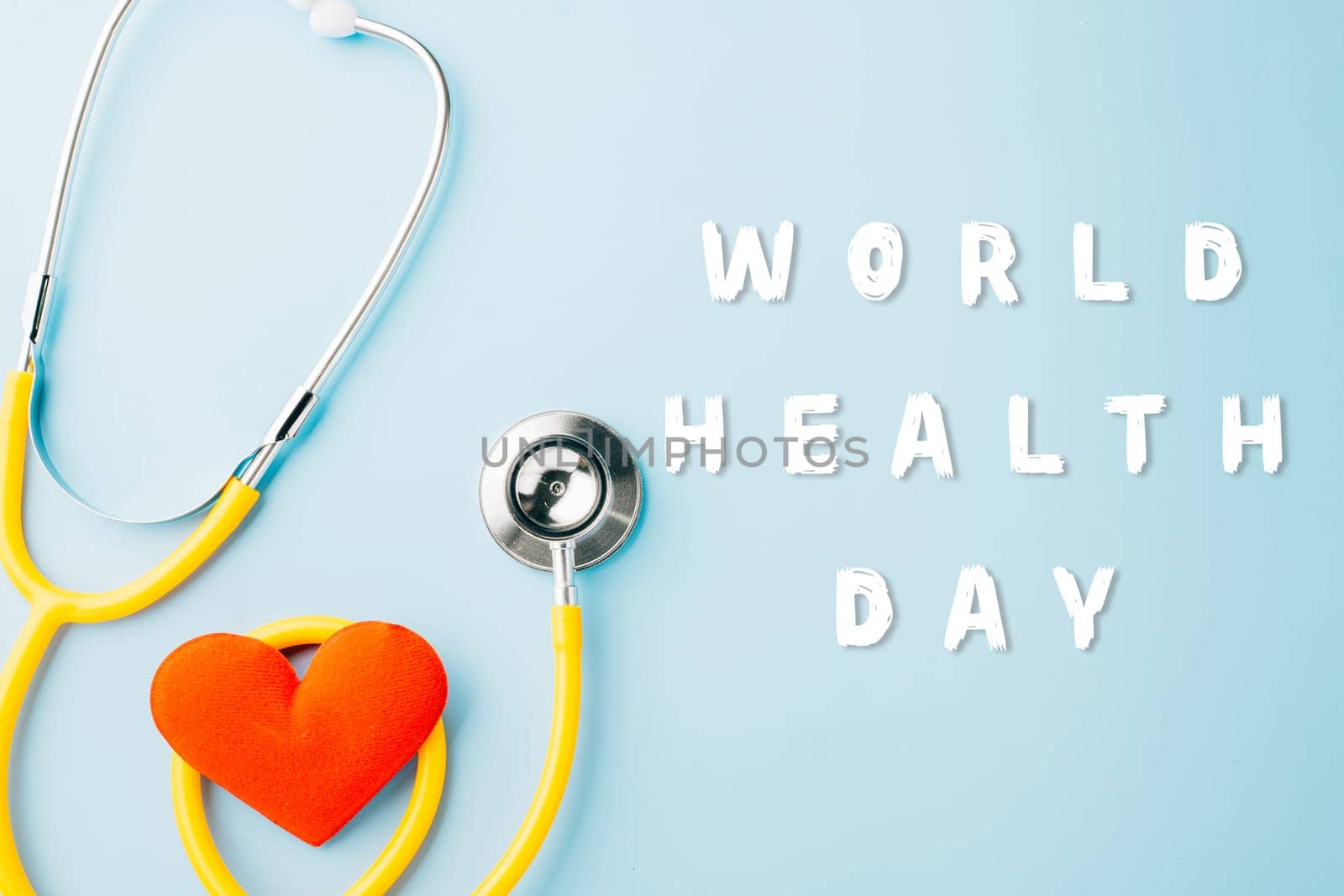 World Health Day. Yellow doctor stethoscope and world globe with Red heart shape isolated on blue background with copy space, Save world day, Healthcare life Insurance, Health care and medical concept