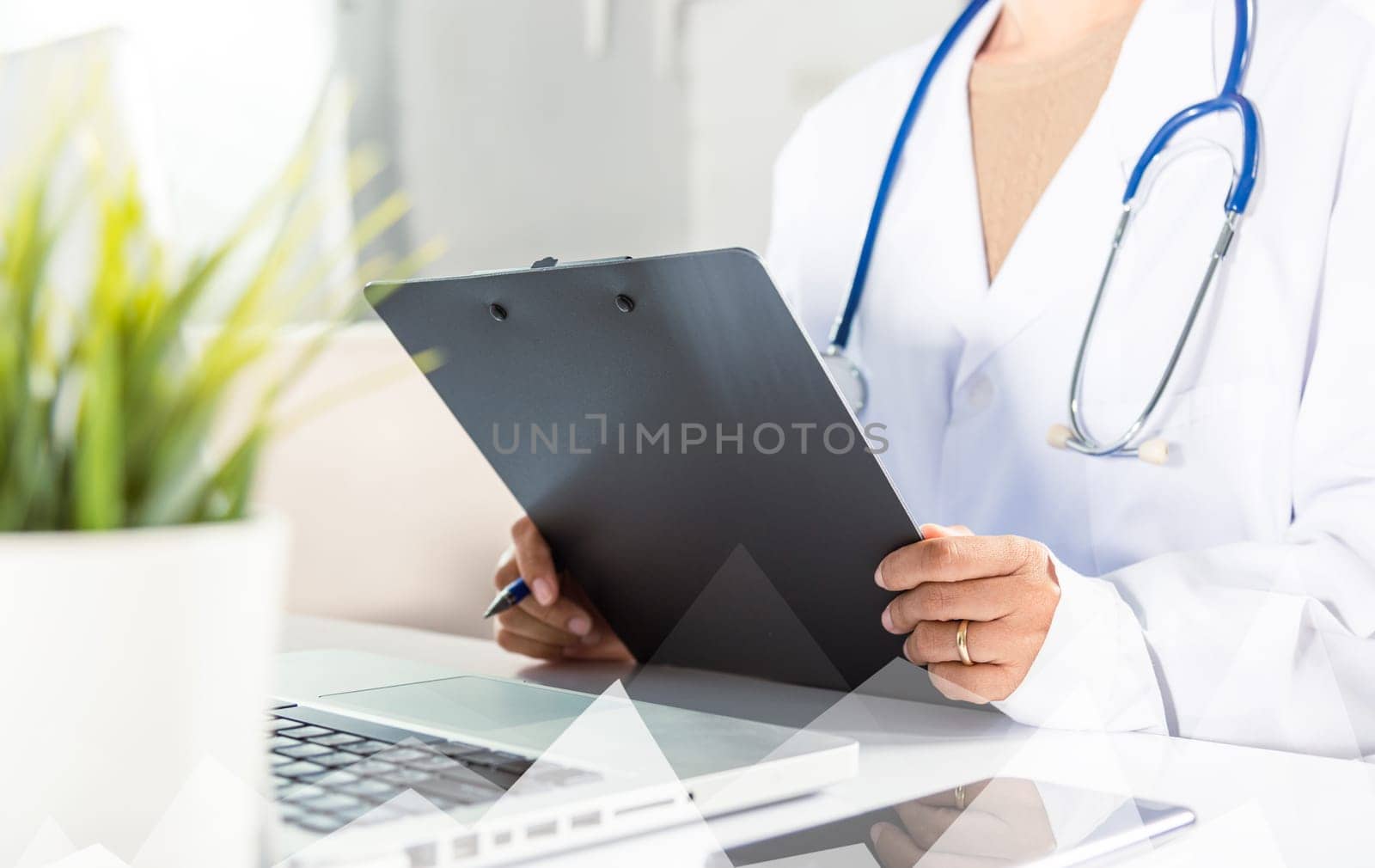 Doctor Day Concept. Nurse in uniform with doctor stethoscope writing information of patient prescription medical in paperwork checklist on clipboard on front laptop, Medical and Health care insurance