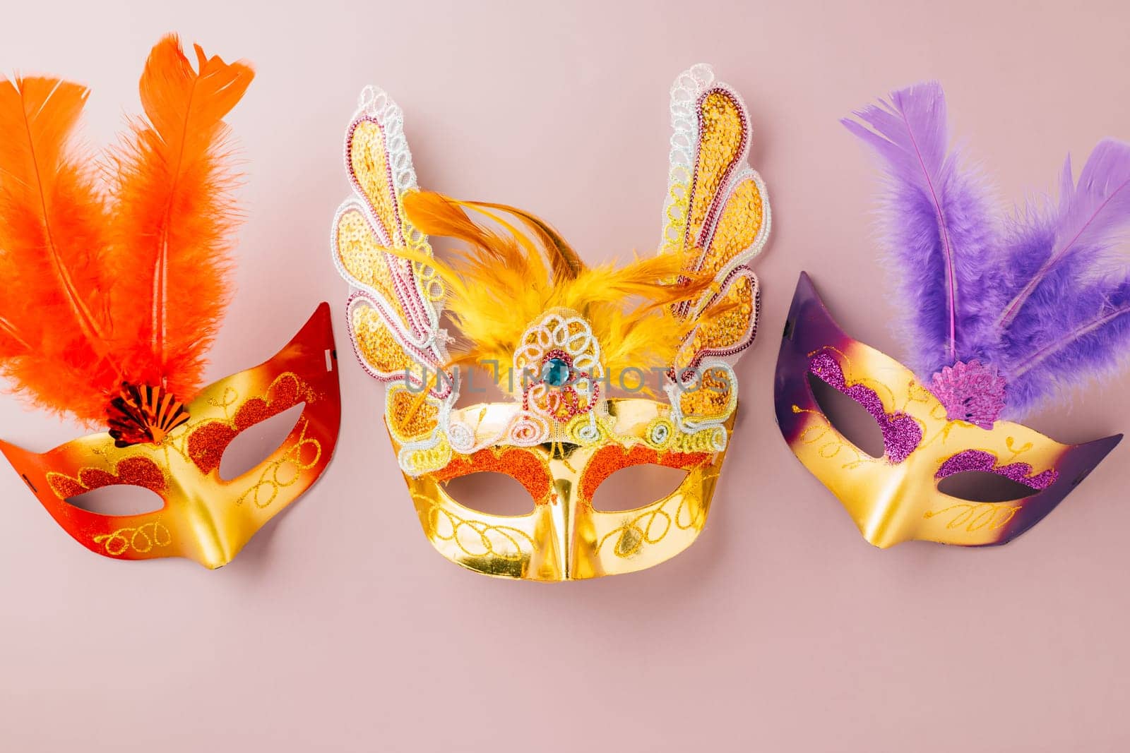 Happy Purim carnival. Carnival mask for Mardi Gras celebration isolated on purple background banner design with copy space, jewish holiday, Purim in Hebrew holiday carnival ball, Venetian mask