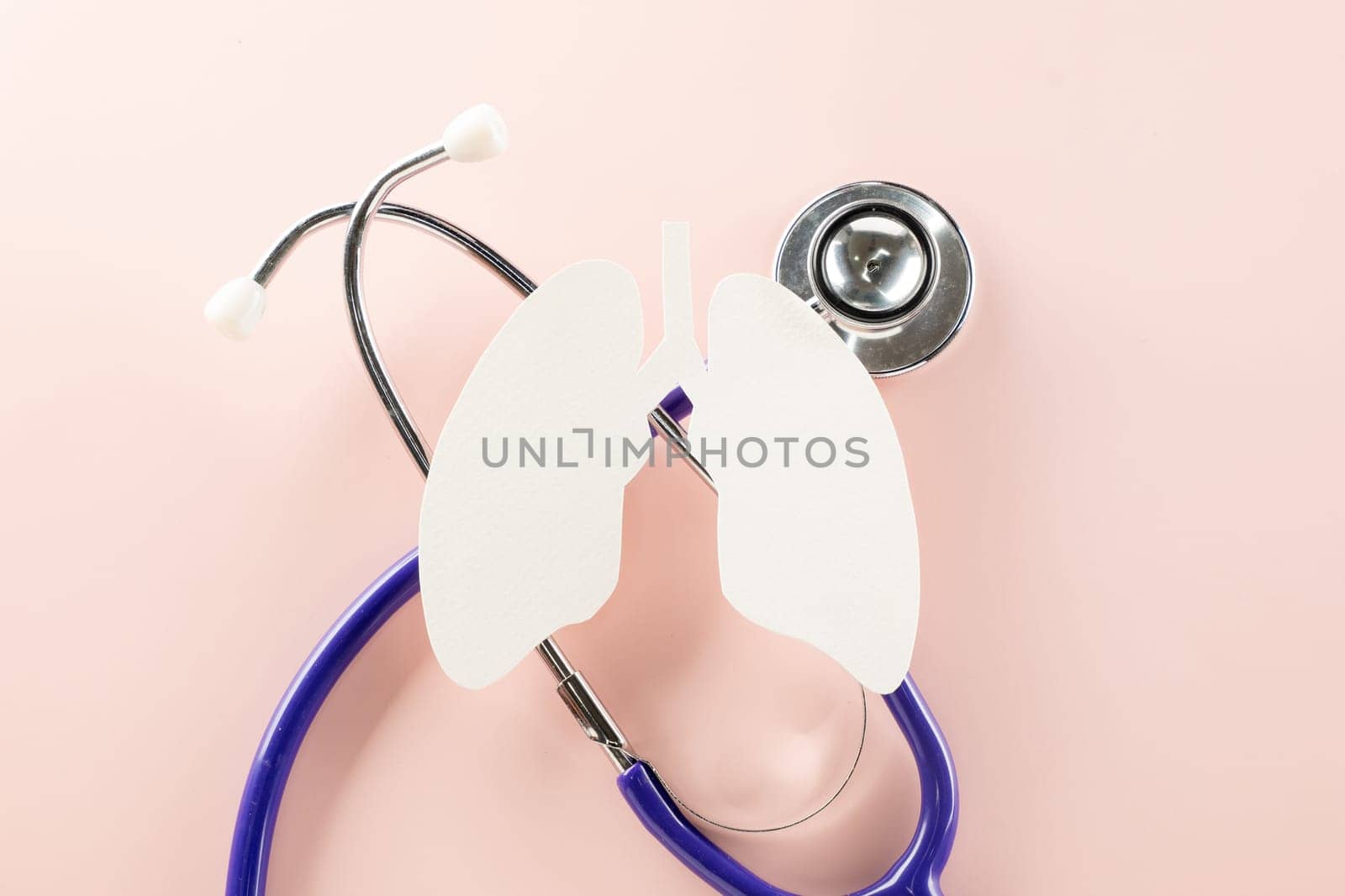 World tuberculosis day. Lungs paper cut symbol and medical stethoscope on pastel pink background, copy space, concept of world TB day, banner background, respiratory diseases, lung cancer awareness
