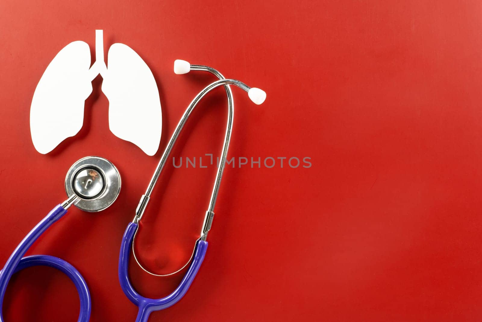 World tuberculosis day. Lungs paper cutting symbol and medical stethoscope on red background, copy space, concept of world TB day, banner background, respiratory diseases, lung cancer awareness