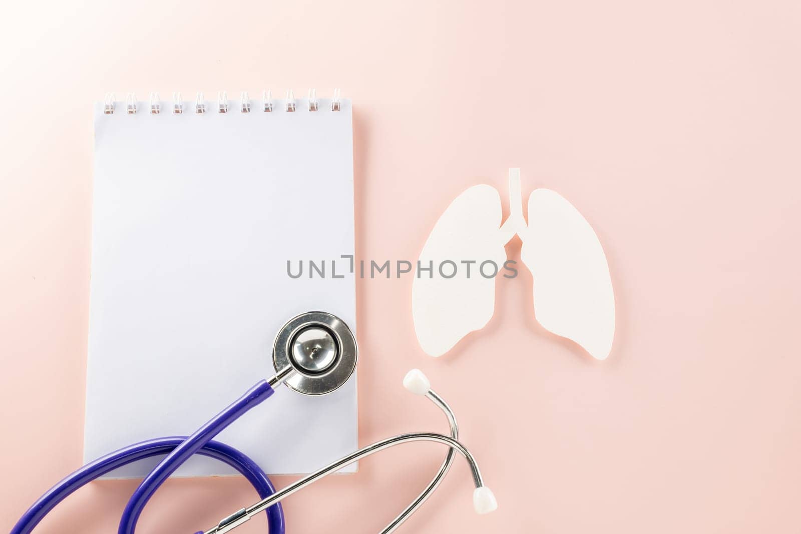 World TB Day. Top view lungs paper symbol, medical stethoscope and notebook paper on pastel pink background, lung cancer awareness, copy space concept of world tuberculosis day, banner background