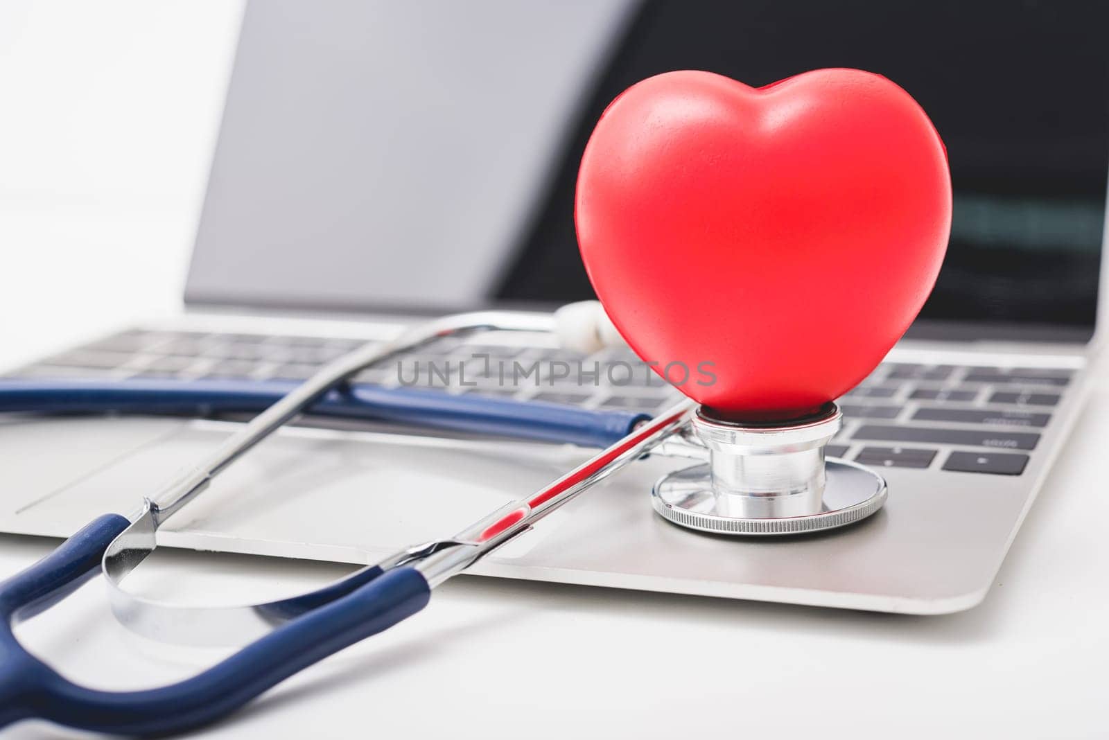 Doctor Day Concept, Health doctor stethoscope and red heart on keyboard of laptop computer with copy space, care patient in hospital, Medical and Healthcare insurance, RX prescription
