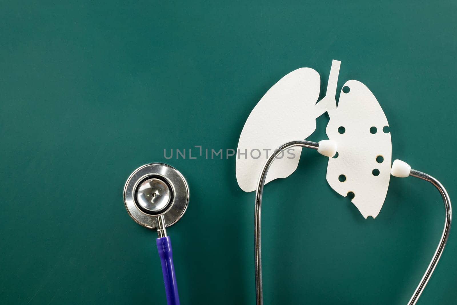 World tuberculosis day. Lungs paper cutting symbol and medical stethoscope on green background, copy space, concept of world TB day, banner background, respiratory diseases, lung cancer awareness