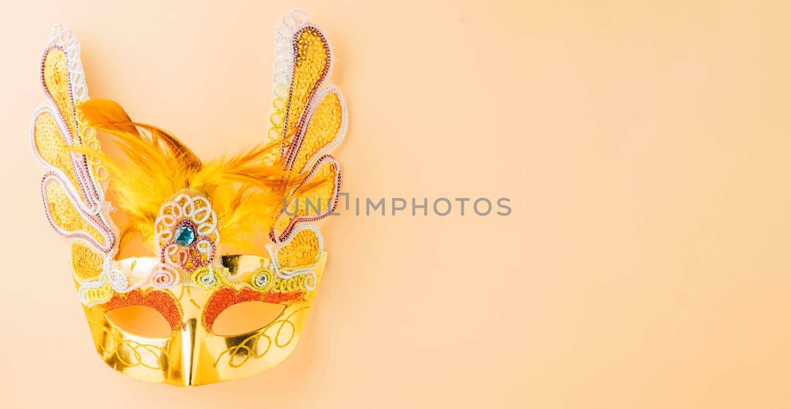 Happy Purim carnival decoration. Jewish Purim and Mardi Gras in Hebrew, celebration holiday background banner design, Golden venetian ball mask, carnival mask isolated on pastel background