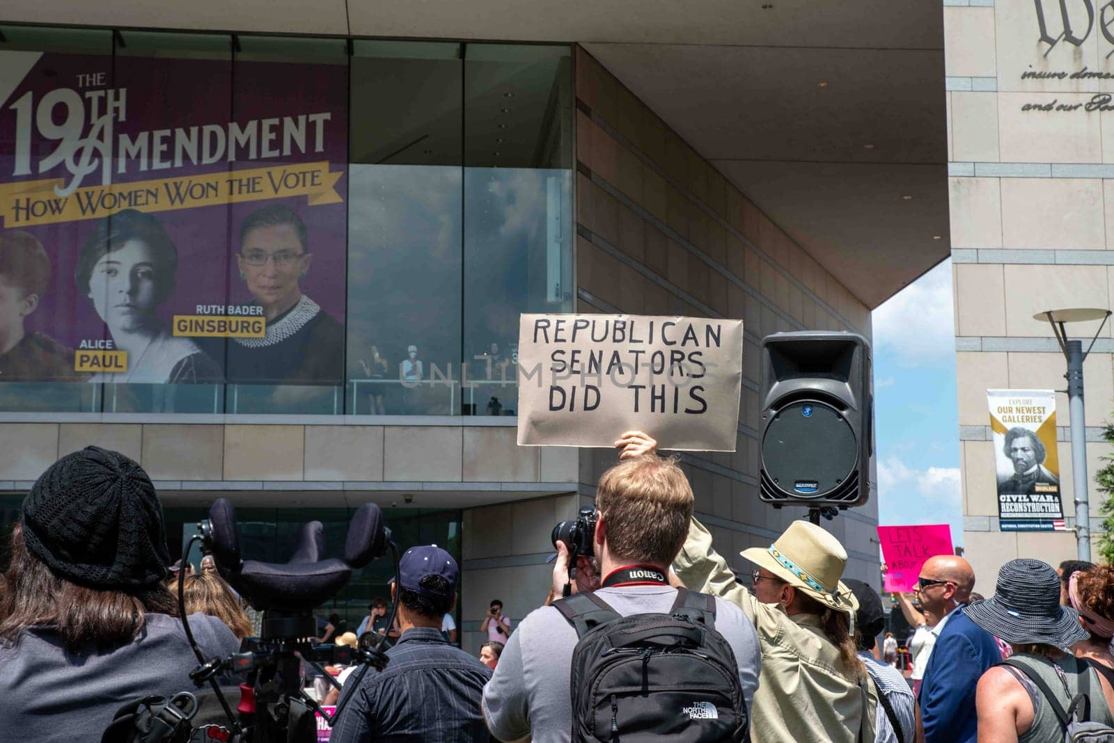 Philadelphia, PA USA - 06-25-2002 Crowd at pro-choice Josh Shapiro rally, man holds sign that reads Republican Sentaors Did This. Crowd of men and women with protest signs, photographers in sunny outdoor political rally. Images of Ruth Bader Ginsburg and Alice Paul look down from the Constitution Center. Editorial use only.