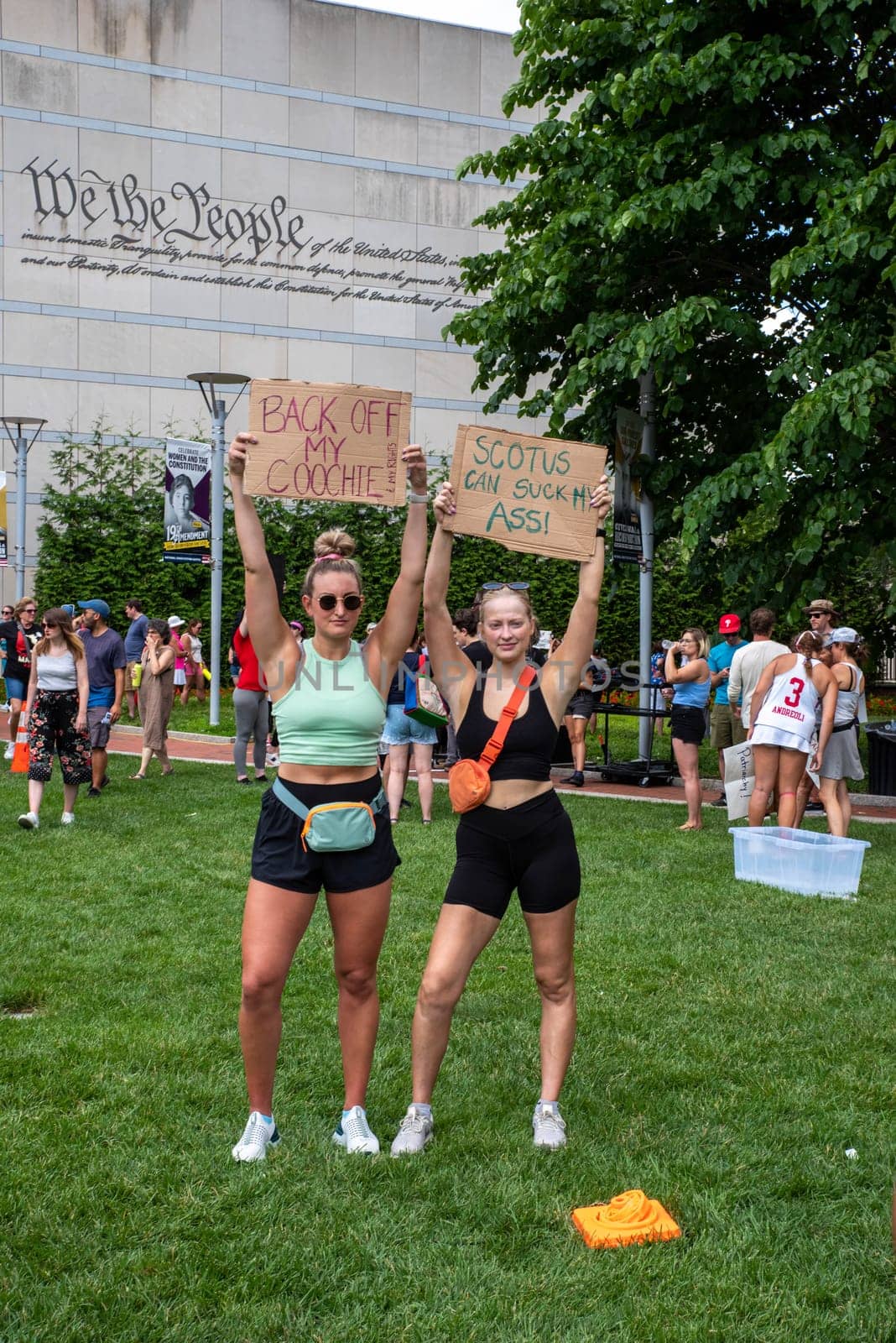 Philadelphia, PA USA 06-25-2002 Two young women hold up feminist protest signs at pro-choice political rally with a crowd gathering behind them. Josh Shapiro rally. Editorial use only.