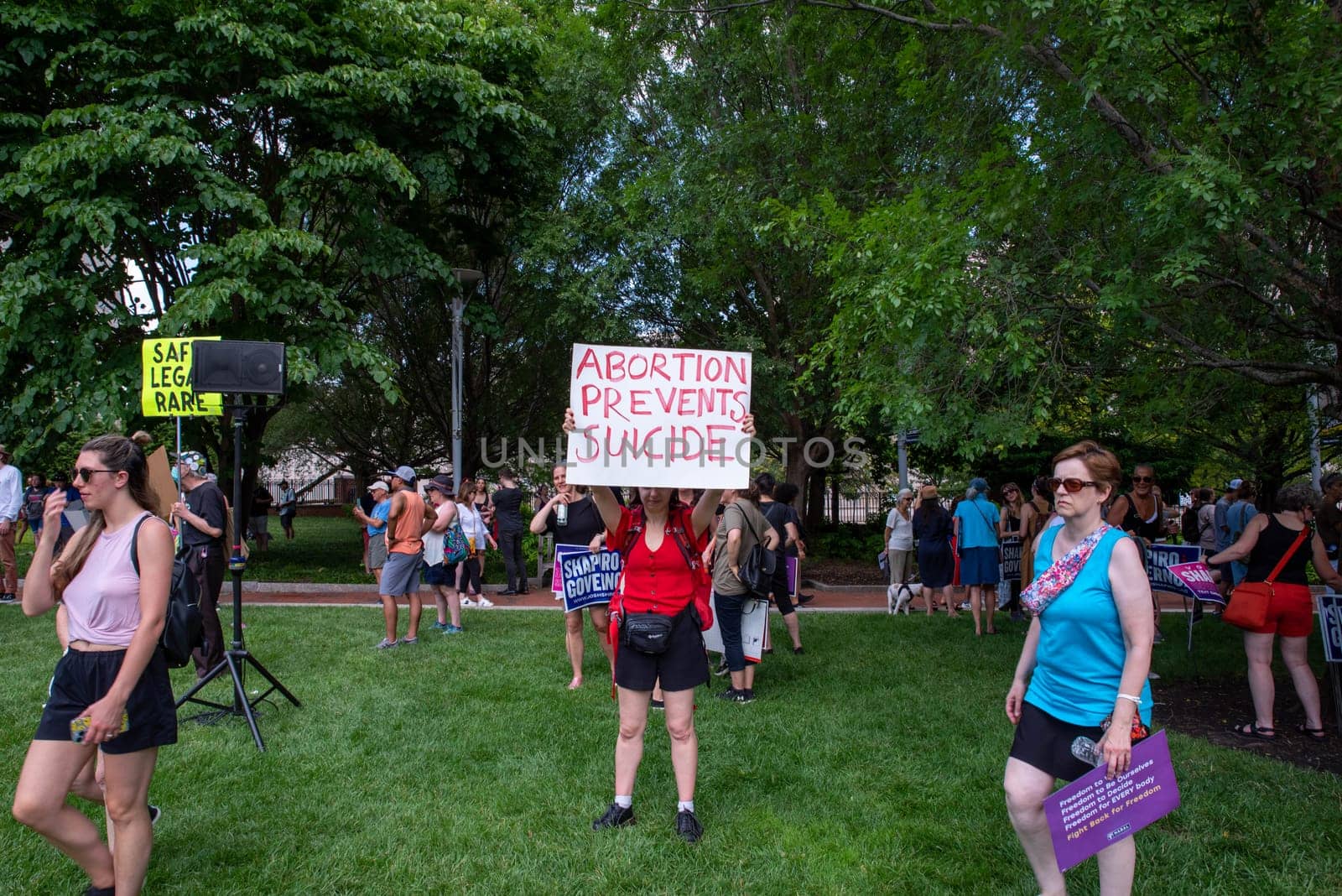 Philadelphia, PA USA - 06-25-2002 Woman at a political pro-choice rally holds a feminist sign that reads ABORTION PREVENTS SUICIDE as other demonstrators gather. Josh Shapiro rally. Editorial use only.