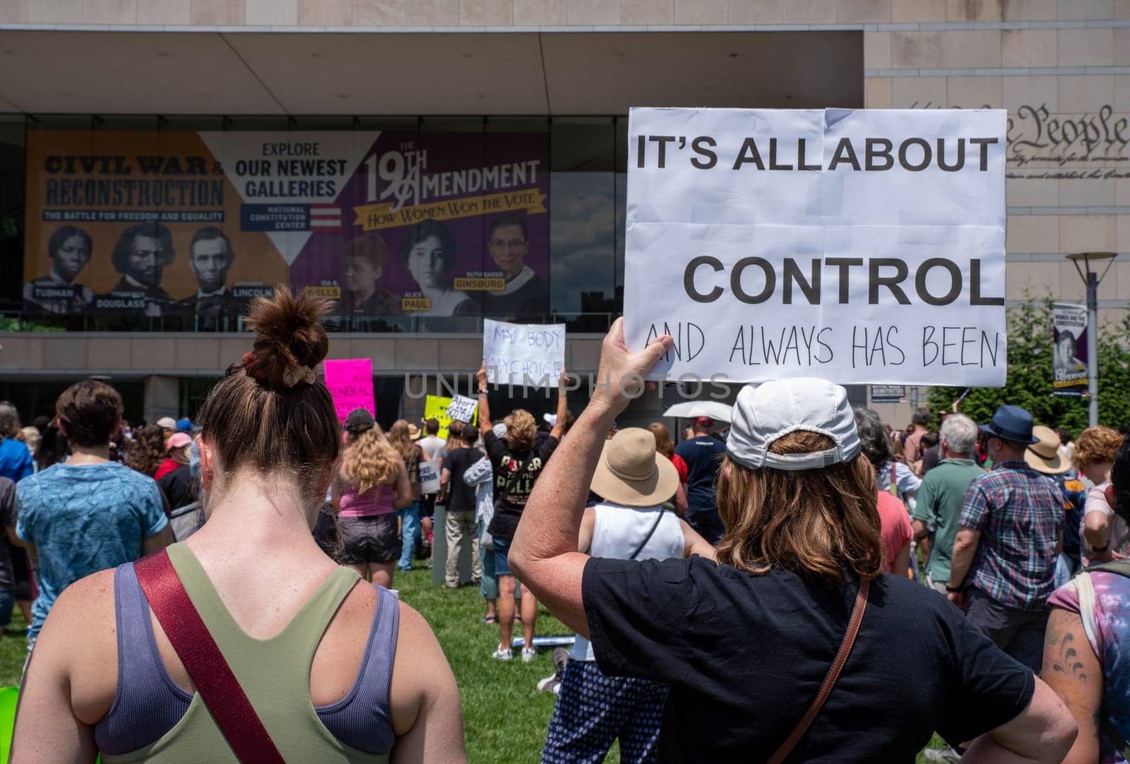 Philadelphia, PA / USA-06/25/2022: Woman holds a pro-choice feminist sign at a pro-choice rally IT'S ALL ABOUT CONTROL. Large crowd of women and men. Editorial use only.